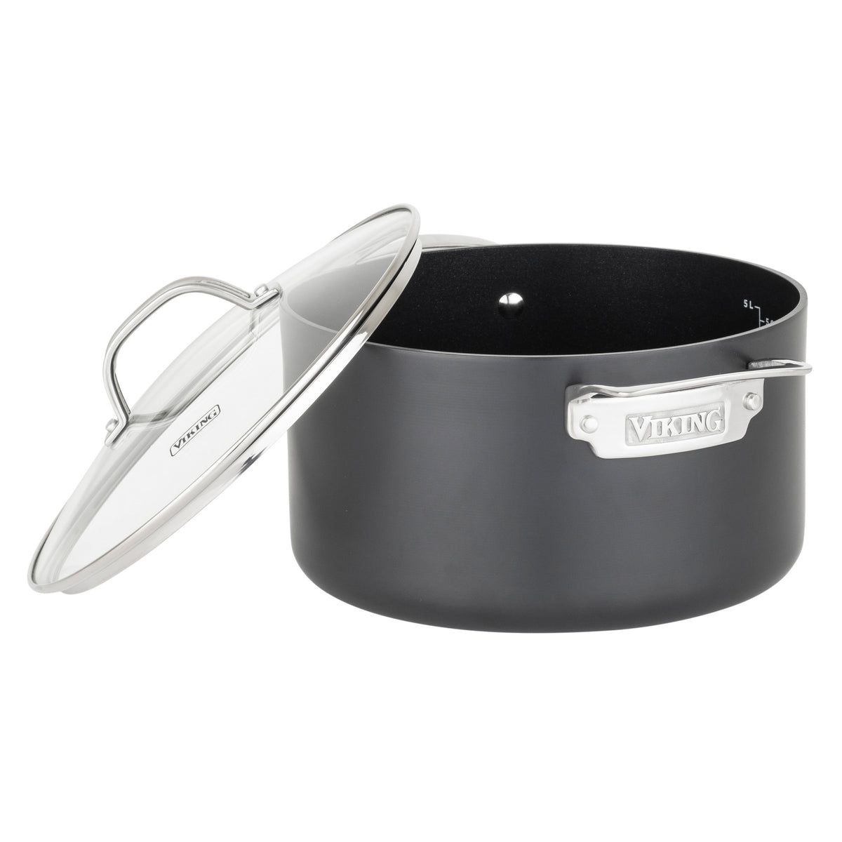 A black Viking Culinary Products Hard Anodized Ceramic Nonstick pot from the 12pc set, featuring two metal handles and a clear glass lid, is shown slightly tilted and resting against its edge.