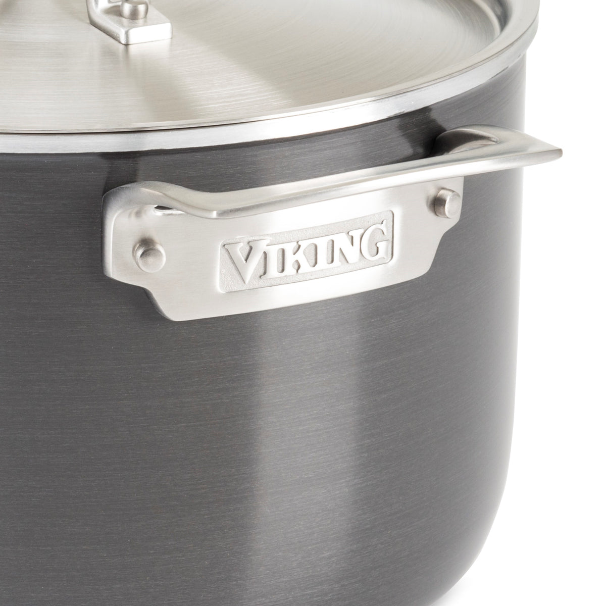 Close-up of a dark gray Viking cookware pot with a brushed stainless steel handle and lid. The brand name Viking is engraved on the handle.