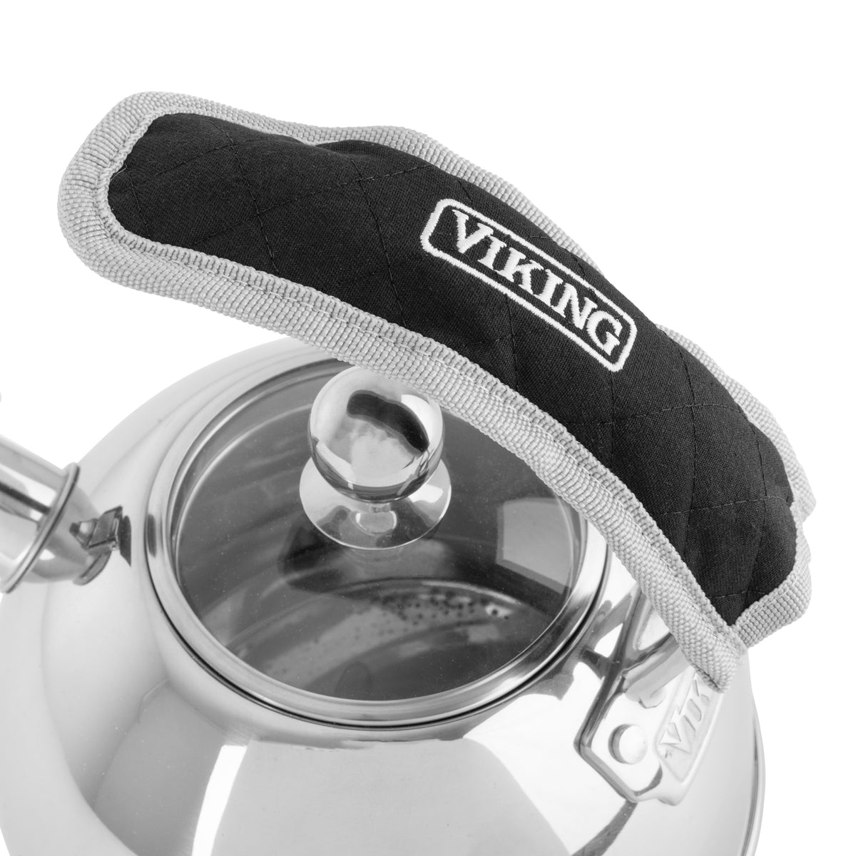 A stainless steel kettle with a glass lid is shown. The kettles handle is covered with a black and gray quilted fabric cover labeled VIKING for heat protection.