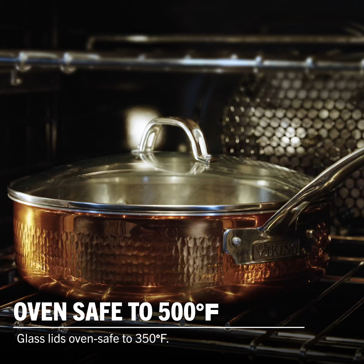A Viking Culinary Products 3-Ply Hammered Copper Clad pan with stainless steel interior and tempered glass lid sits on an oven rack. Oven safe to 500°F; glass lids oven-safe to 350°F.
