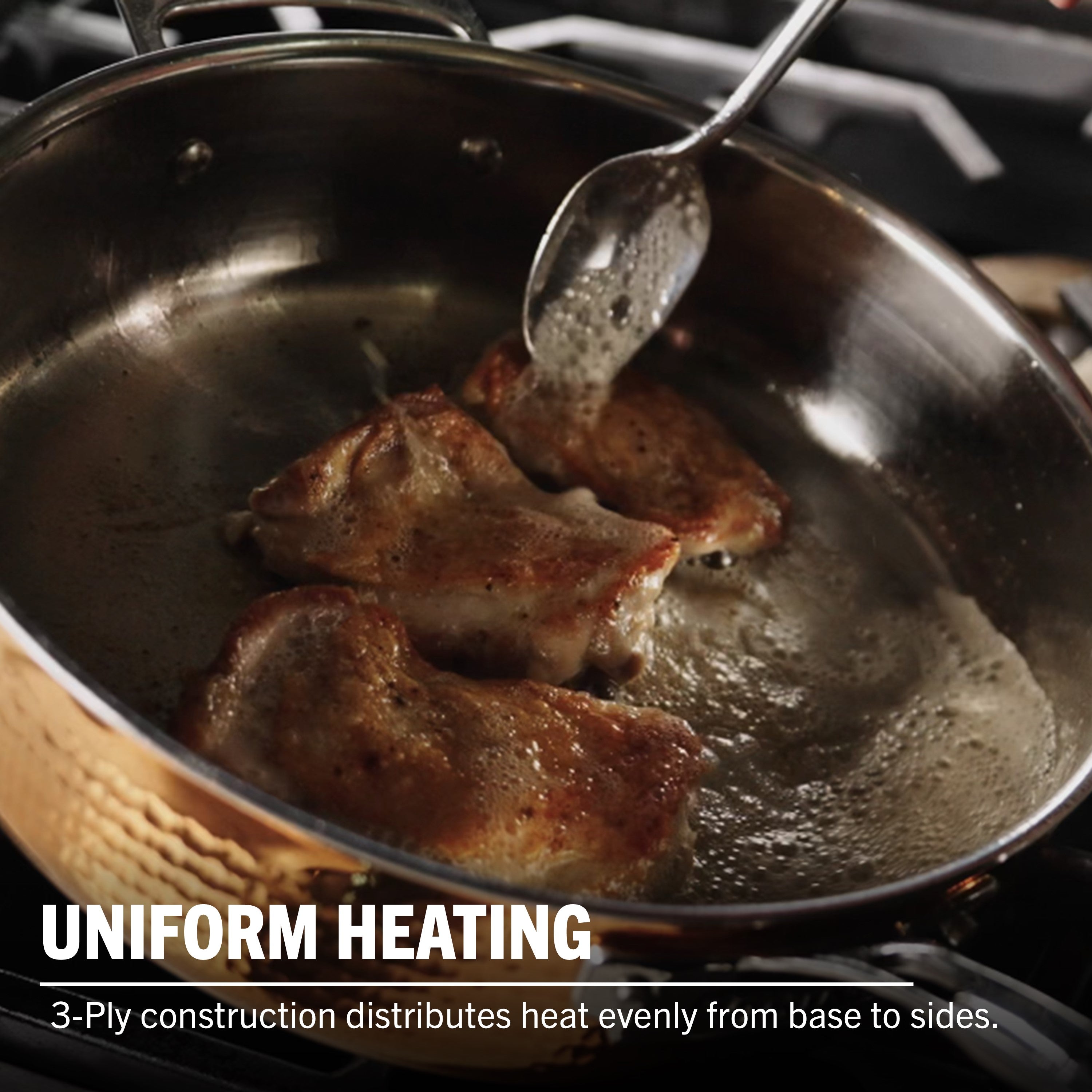 Chicken is being seared and basted in Viking Culinary Products’ 3-Ply Hammered Copper Clad Cookware. Uniform heating from the stainless steel interior ensures even cooking. Text: CONSISTENT HEAT. 3-Ply construction delivers optimal heat distribution.