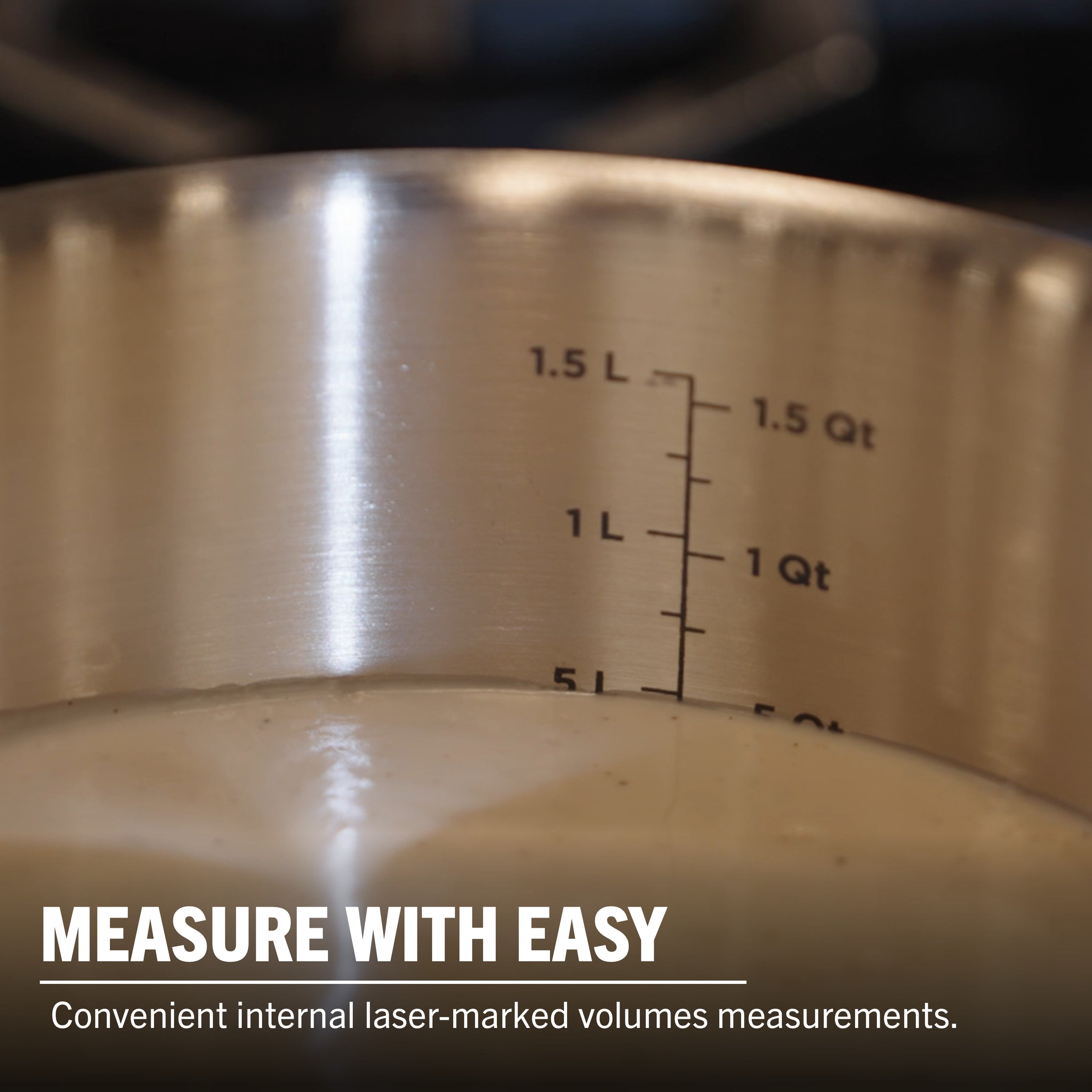 A close-up of the Viking Artisan 3-ply Stainless Steel 11-Piece Cookware Set by Viking Culinary Products shows internal laser-marked liter and quart measurements. Oven safe, induction compatible—cook with ease.