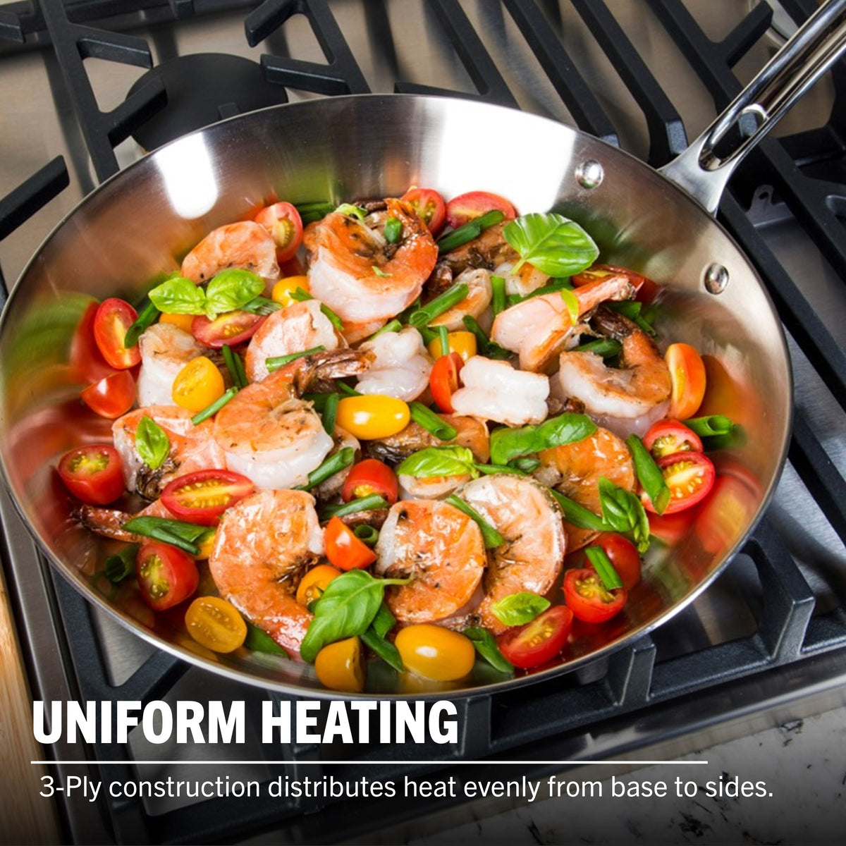 A Viking Contemporary 3-Ply Stainless Steel Cookware Set by Viking Culinary Products sits on the stovetop with shrimp and tomatoes. Induction compatible and oven safe, this set distributes heat evenly from base to sides.