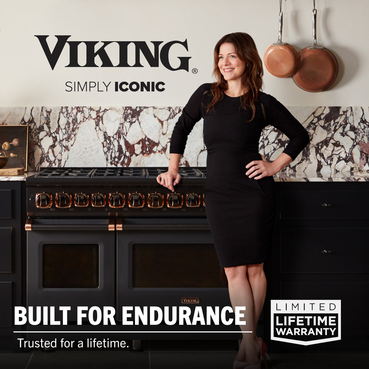 A woman stands in a modern kitchen beside Viking Culinary Products’ 3-Ply Hammered Copper Clad 10-Piece Cookware Set with Glass Lids. A marble backsplash is behind her. Text: "Viking Simply Iconic. Built for endurance. Limited lifetime warranty.