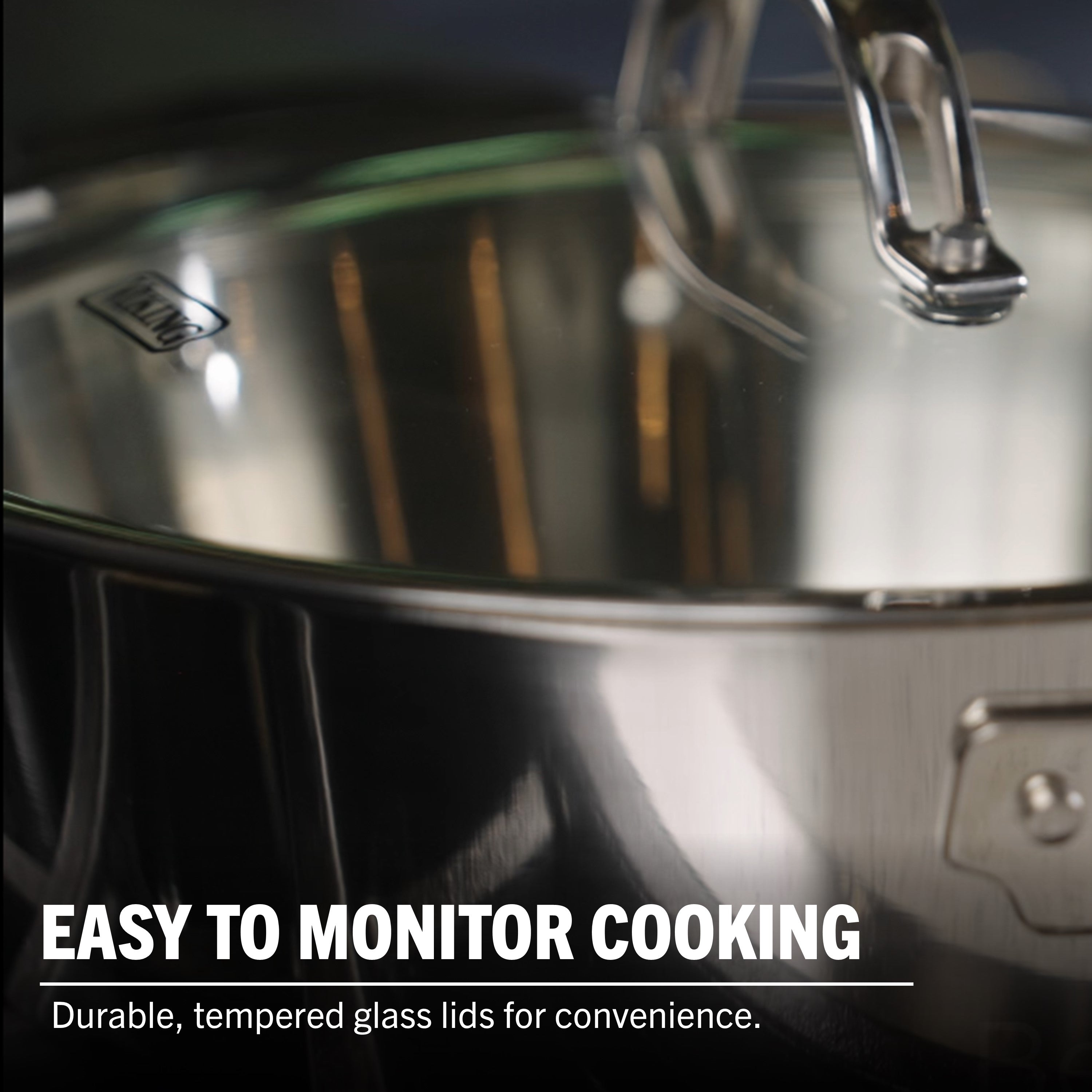 Close-up of the Viking Contemporary 3-Ply 4.8-Quart Sauté Pan with a clear tempered glass lid. Text: Easily monitor cooking. Durable glass lid for convenience. Induction compatible for versatile use by Viking Culinary Products.