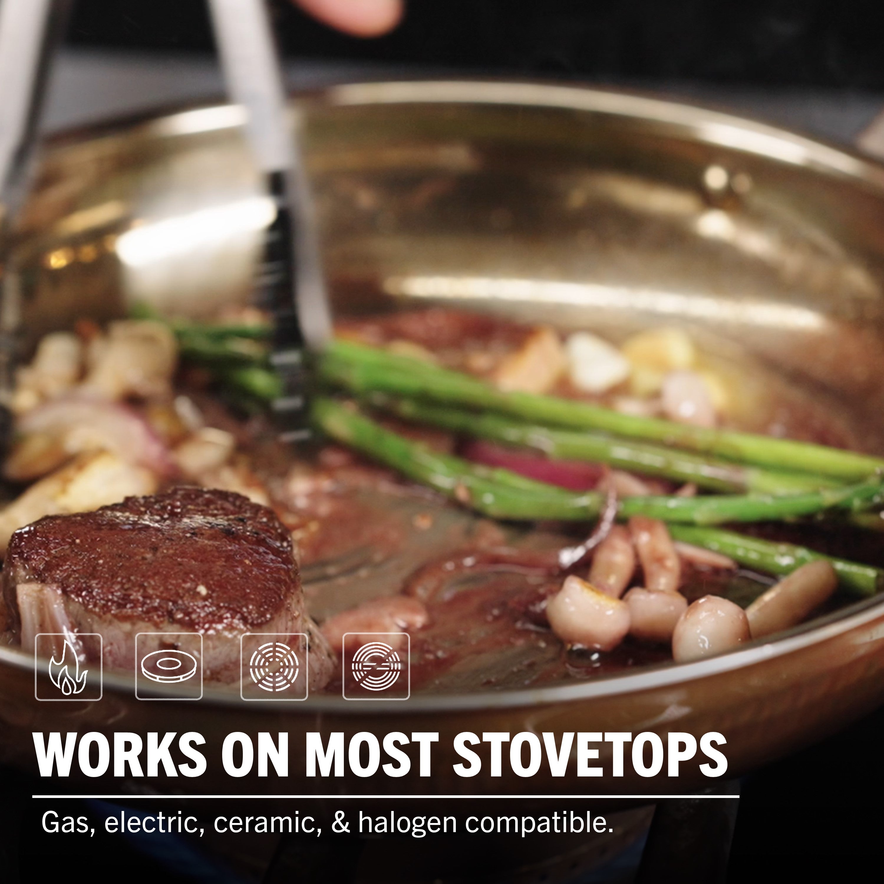 A close-up of steak, asparagus, and beans cooking in a skillet with tongs. Text: Viking 3-Ply Hammered Copper Clad 10-Piece Cookware Set with glass lids by Viking Culinary Products. Compatible with gas, electric, ceramic & halogen stovetops. Icons included.