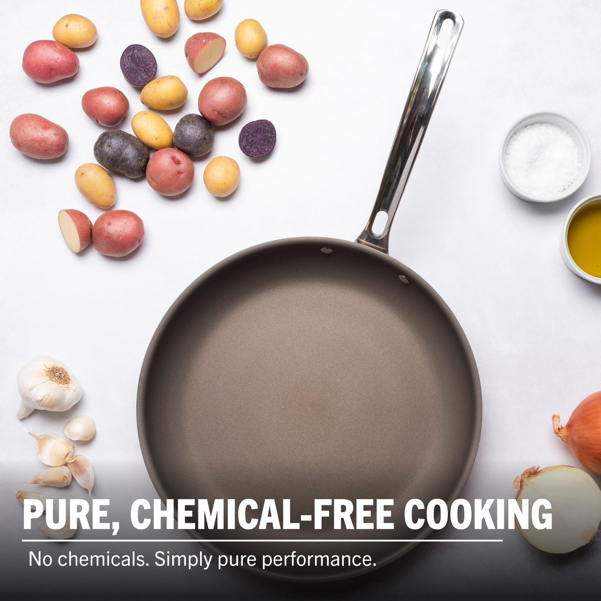 The Viking PureGlide Pro 3-Ply 12 Inch Fry Pan by Viking Culinary Products on a white surface with potatoes, garlic, onion, salt, and oil. Text: Pure, chemical-free cooking. No chemicals. Simply pure performance.