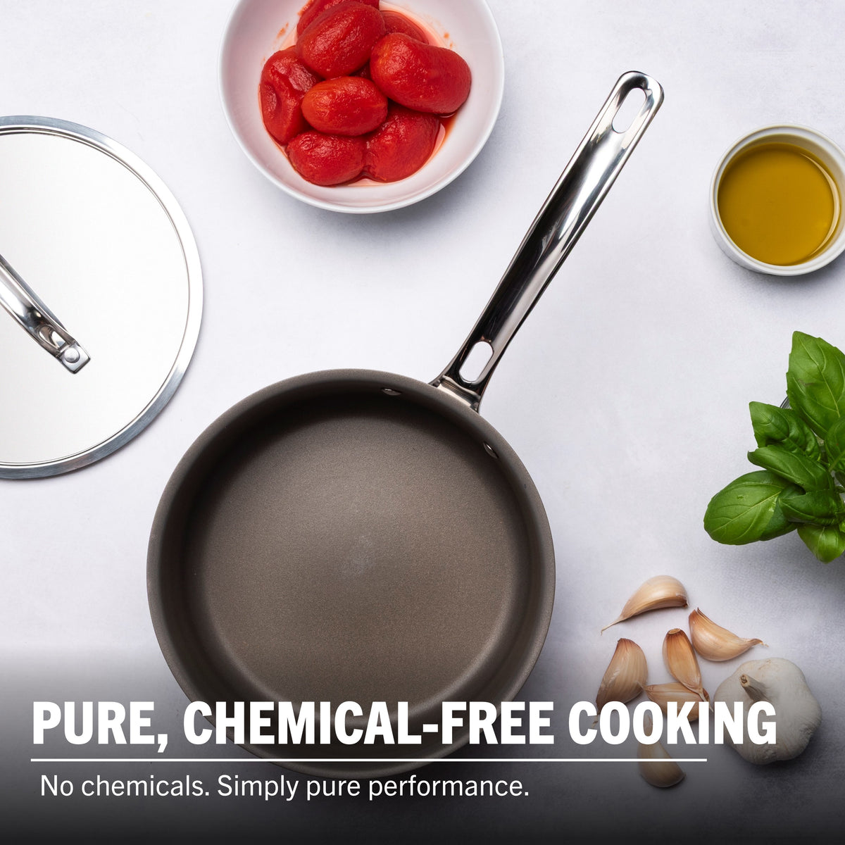 The Viking PureGlide Pro 3-Ply 2-Quart Sauce Pan with Metal Lid by Viking Culinary Products is shown with tomatoes, olive oil, basil, and garlic on a white surface. Text: Pure, chemical-free cooking. No chemicals. Simply pure performance.
