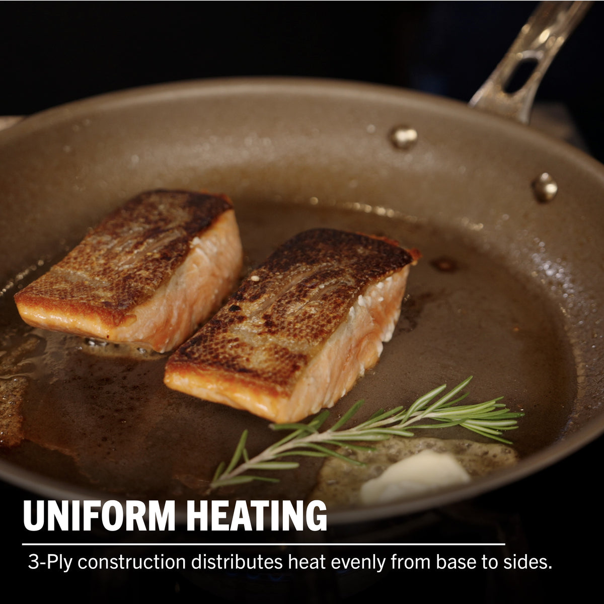 Two salmon fillets with crispy skin cook in a Viking PureGlide Pro 3-Ply Fry Pan. Caption: UNIFORM HEATING—Viking Culinary’s 3-ply design ensures even heat from base to sides for healthier cooking. Set includes 9.5" and 11" pans.