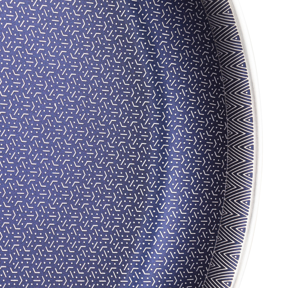 A close-up of the Viking Culinary Products Viking 3-Ply Hybrid Plus 12-inch Nonstick Fry Pan, featuring a sleek surface with a contrasting black and white pattern along the rim.