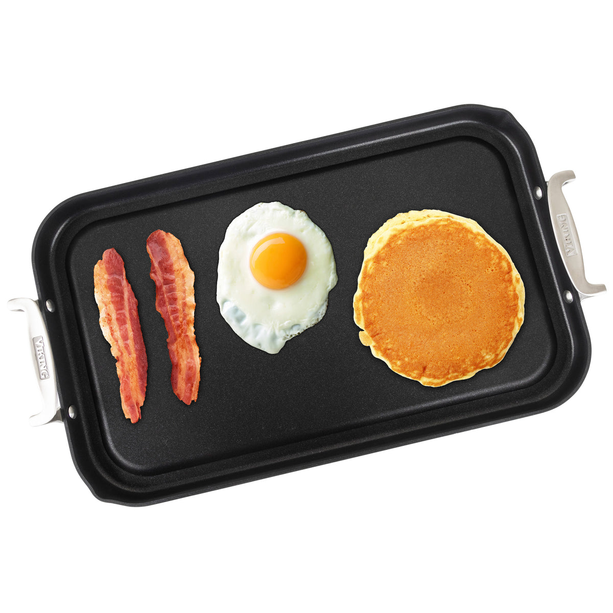 The Viking Hard Anodized Nonstick Double Burner Griddle by Viking Culinary Products holds two strips of cooked bacon, a sunny-side-up egg, and a golden pancake arranged in a row.