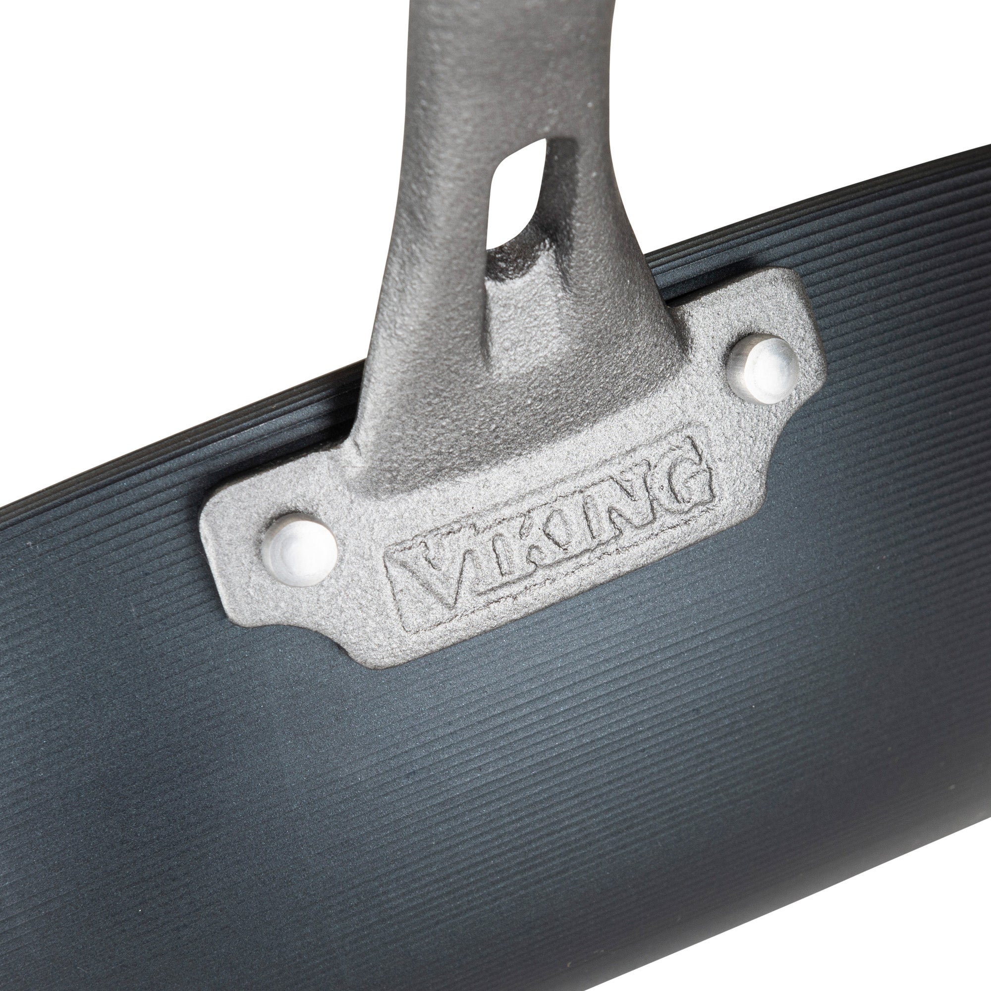 Close-up of a metal handle on a dark, ribbed surface with Viking Culinary Products embossed on a silver plate, showcasing the durable quality of the Viking Blue Carbon Steel 12-Inch Wok.