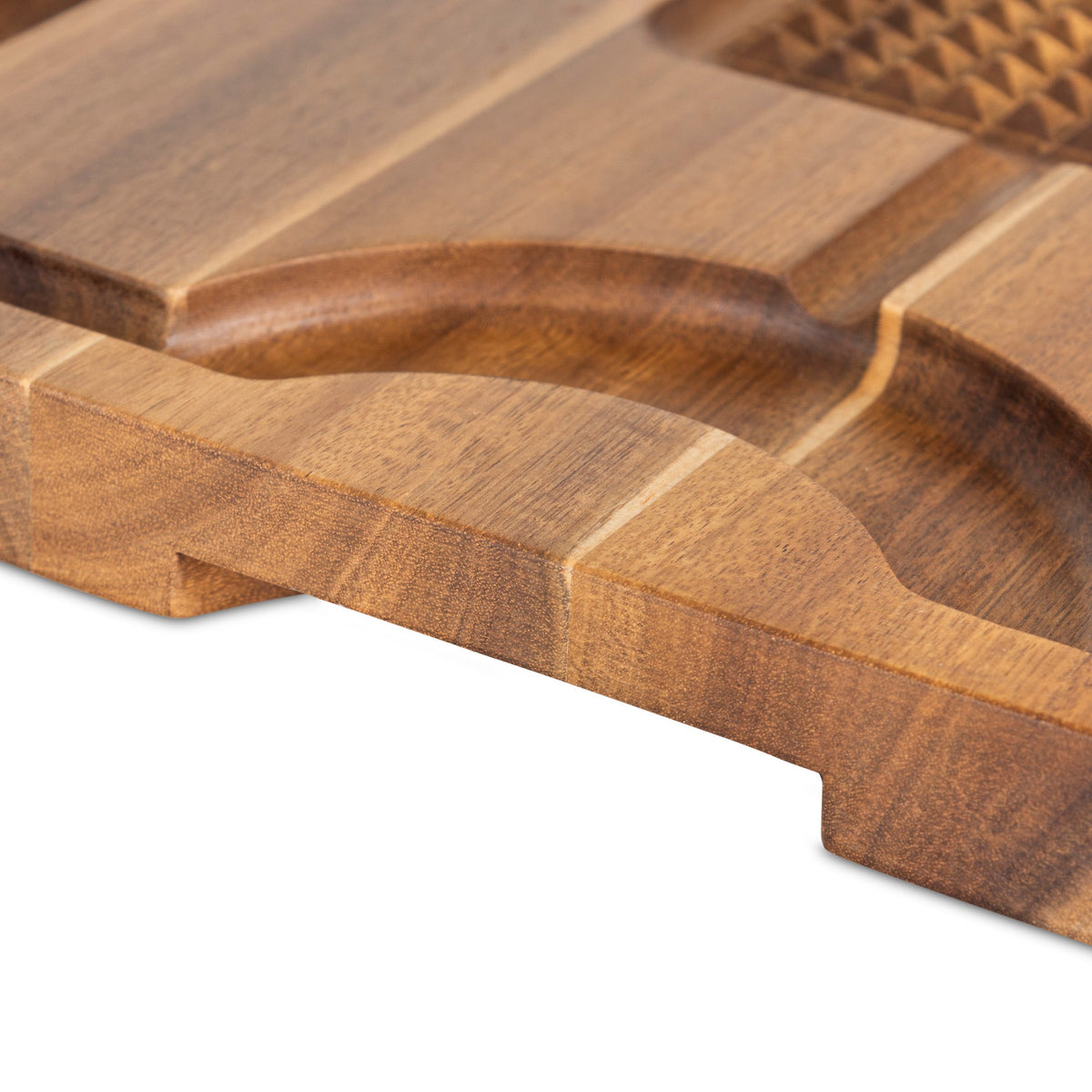 Close-up of the Viking Acacia Wood Cutting Board with 3-Piece Stainless Steel Carving Set by Viking Culinary Products, featuring curved grooves, a recessed section, and detailed wood texture craftsmanship on a white background.