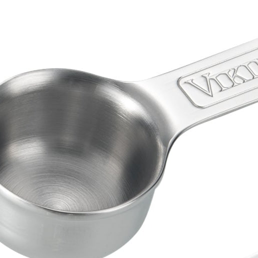 A stainless steel measuring cup with a sturdy handle, featuring the Viking brand name embossed on the handle. The cup is shiny and has a smooth, brushed metal finish.