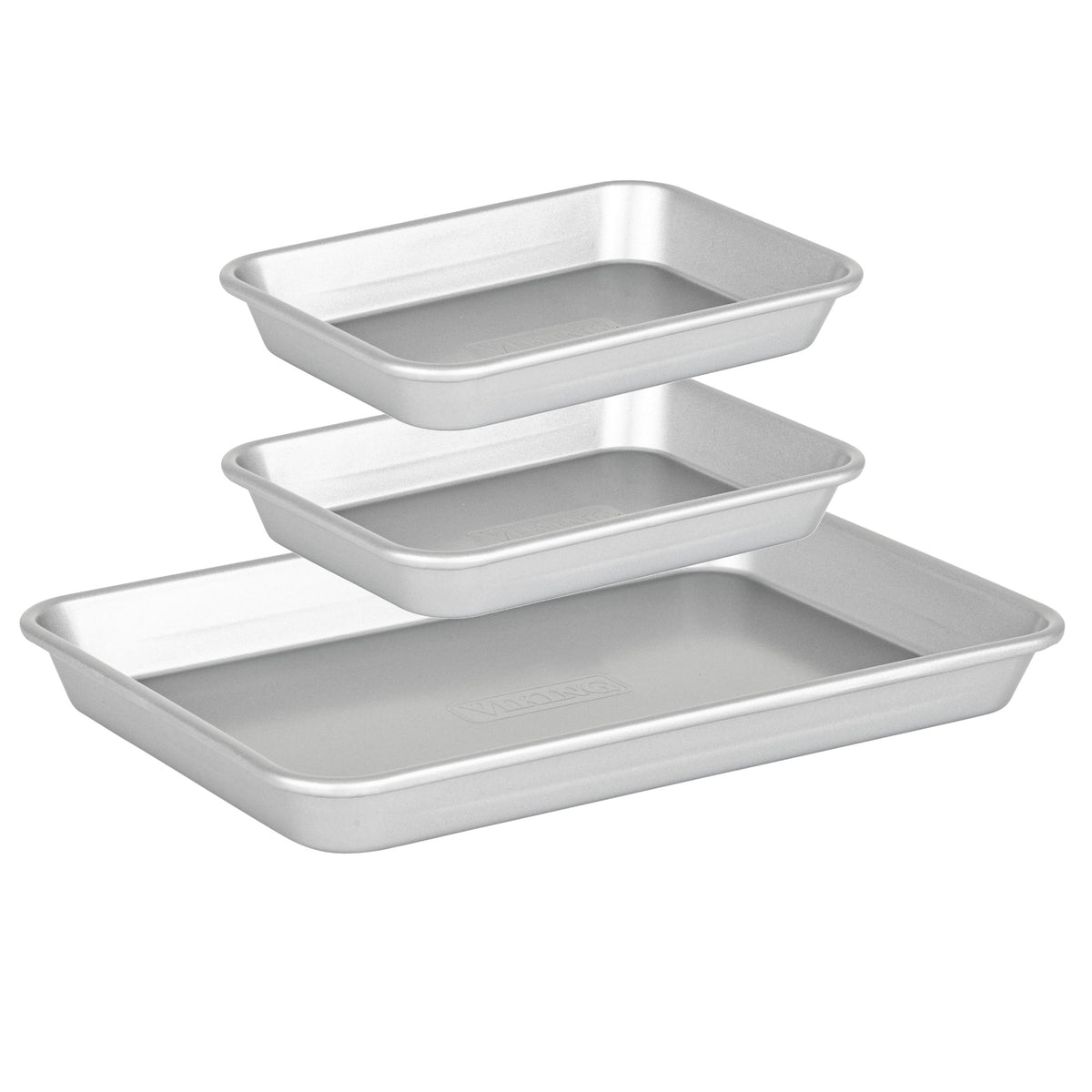 Three silver rectangular pans from the Viking Aluminized Steel Nonstick 3-pc Nesting Baking Sheet Set by Viking Culinary Products are stacked tiered, each slightly elevated, with rounded edges and smooth surfaces.