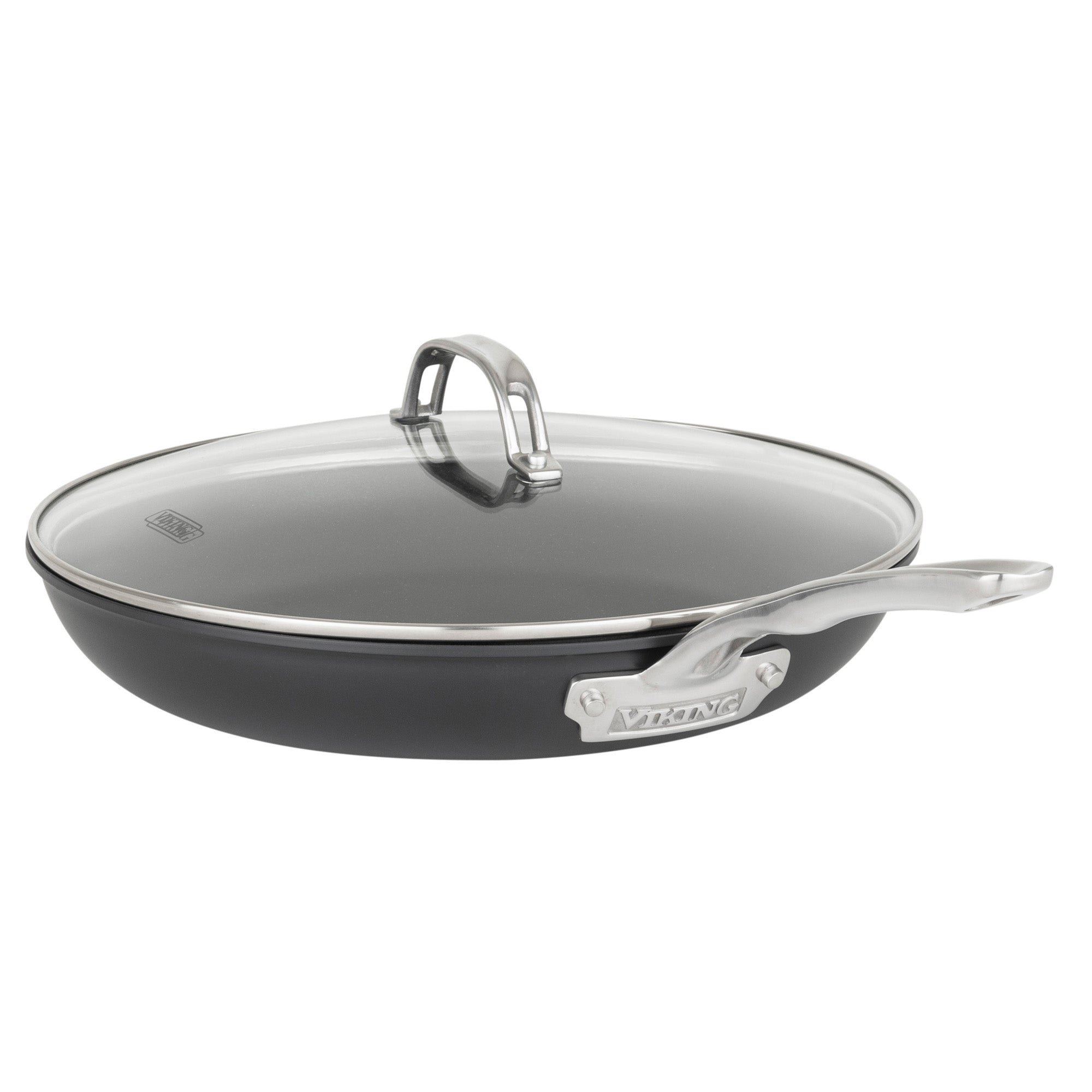 The Viking Hard Anodized Ceramic Nonstick 12pc Cookware Set by Viking Culinary Products includes a PFAS-free nonstick frying pan with a metal handle, fitted glass lid, silver rim, and brand label—ideal for any hard anodized ceramic collection.