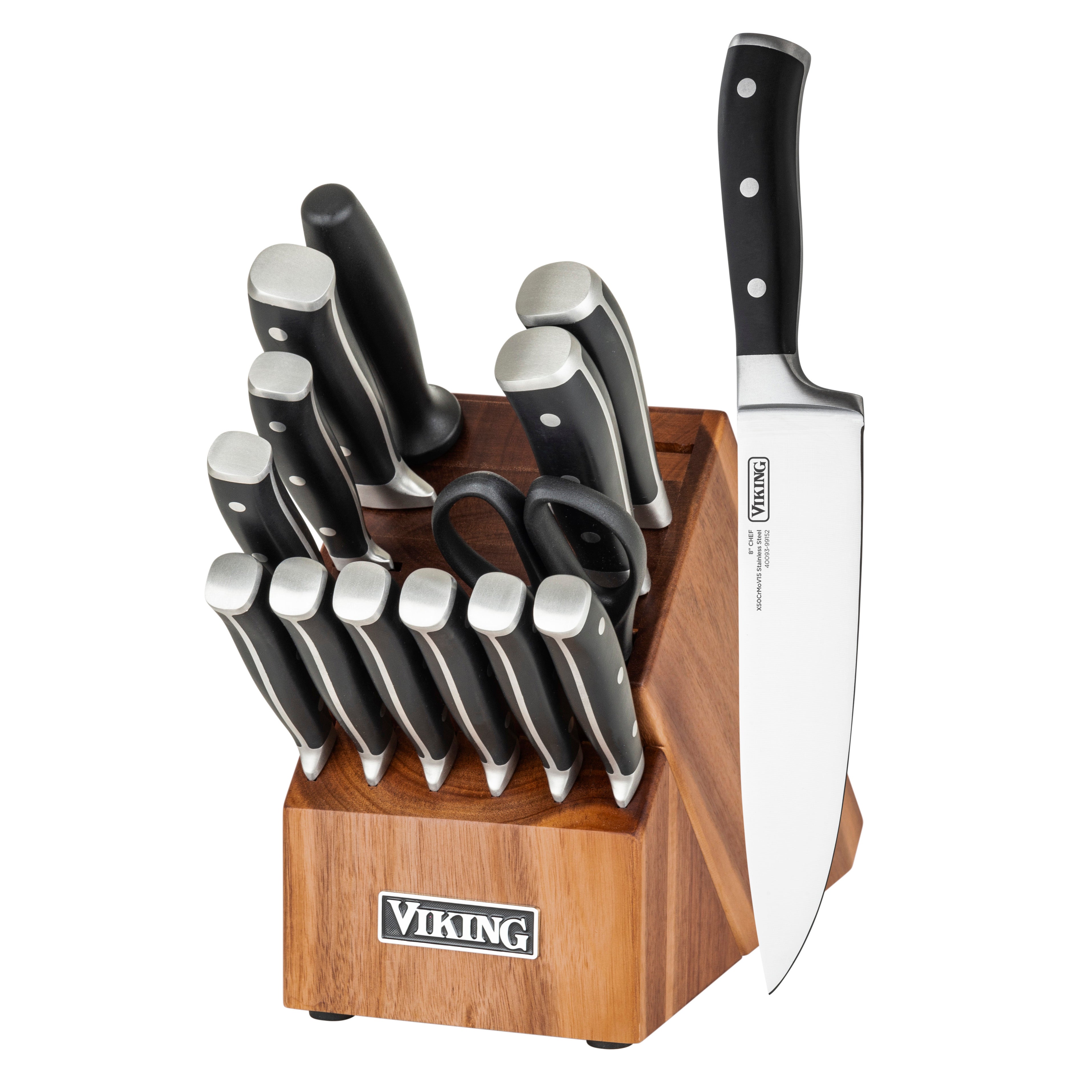 The Viking Culinary Products 15-piece stainless steel cutlery set includes kitchen shears, steak knives, and a sharpening rod in an acacia wood block. A large chef’s knife is upright, showcasing its blade and handle.
