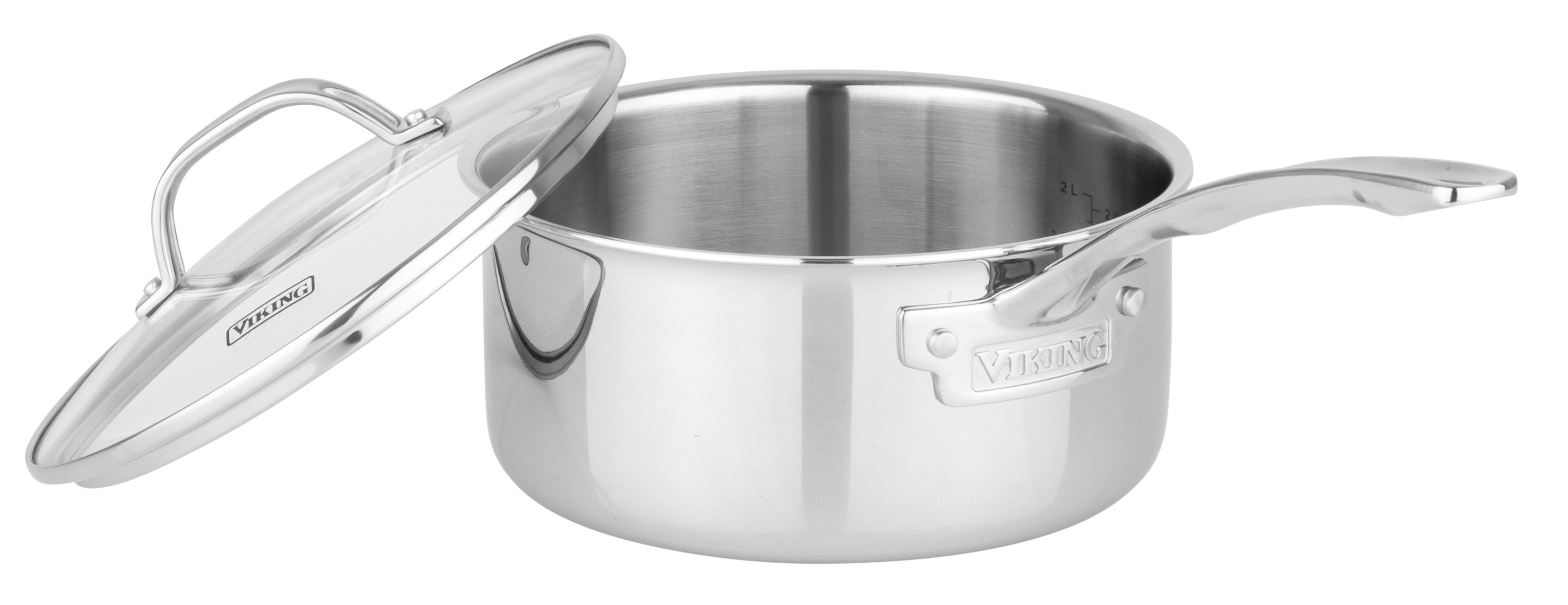 The Viking Culinary Products Artisan 3-ply Stainless Steel saucepan from the 11-piece set features a long handle and an open glass lid resting diagonally against the pot; it's induction compatible and oven safe.