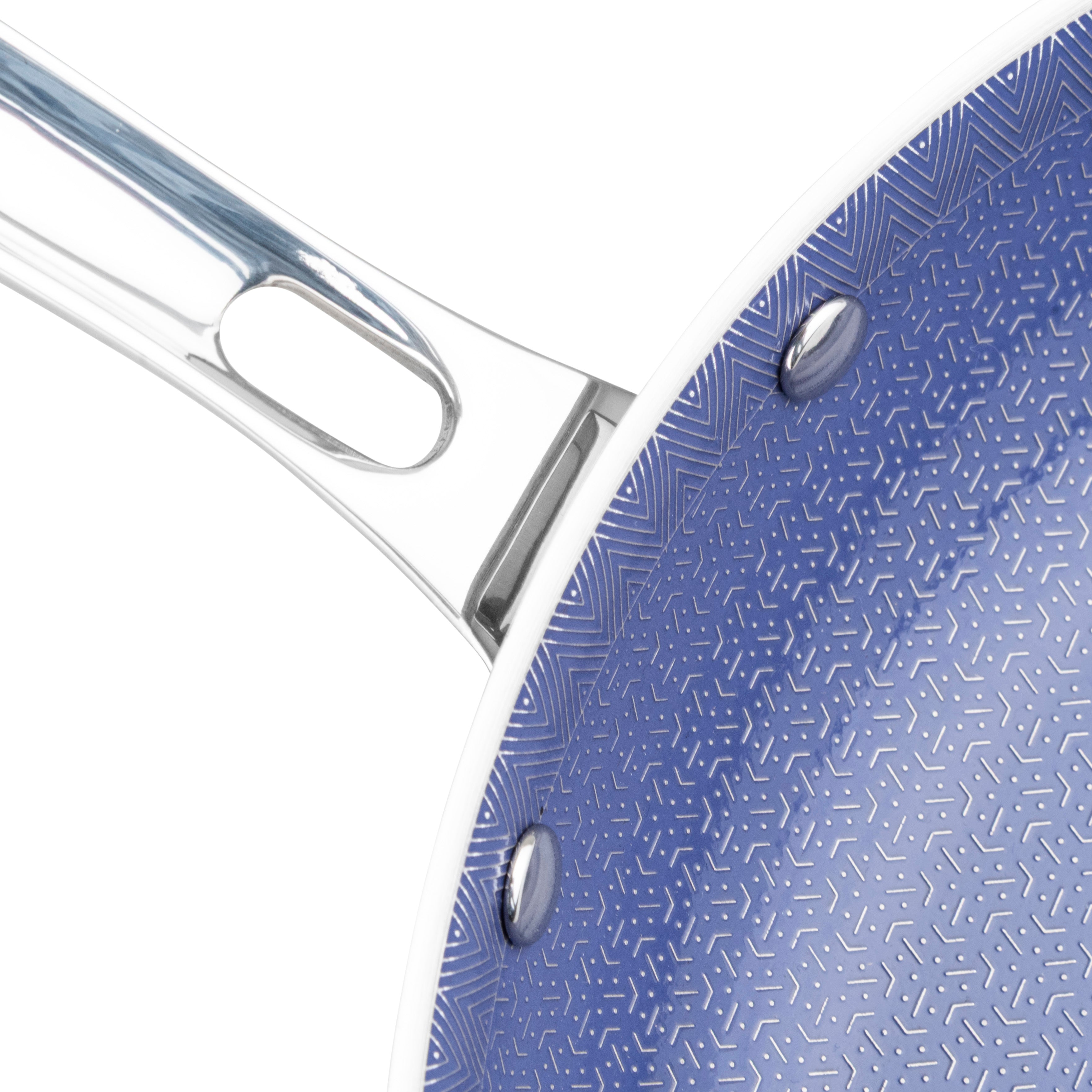 Close-up of the Viking 3-Ply Hybrid Plus Ceramic 12-inch Nonstick Fry Pan by Viking Culinary Products, featuring a shiny metal handle, blue geometric-patterned nonstick interior, and two visible rivets.