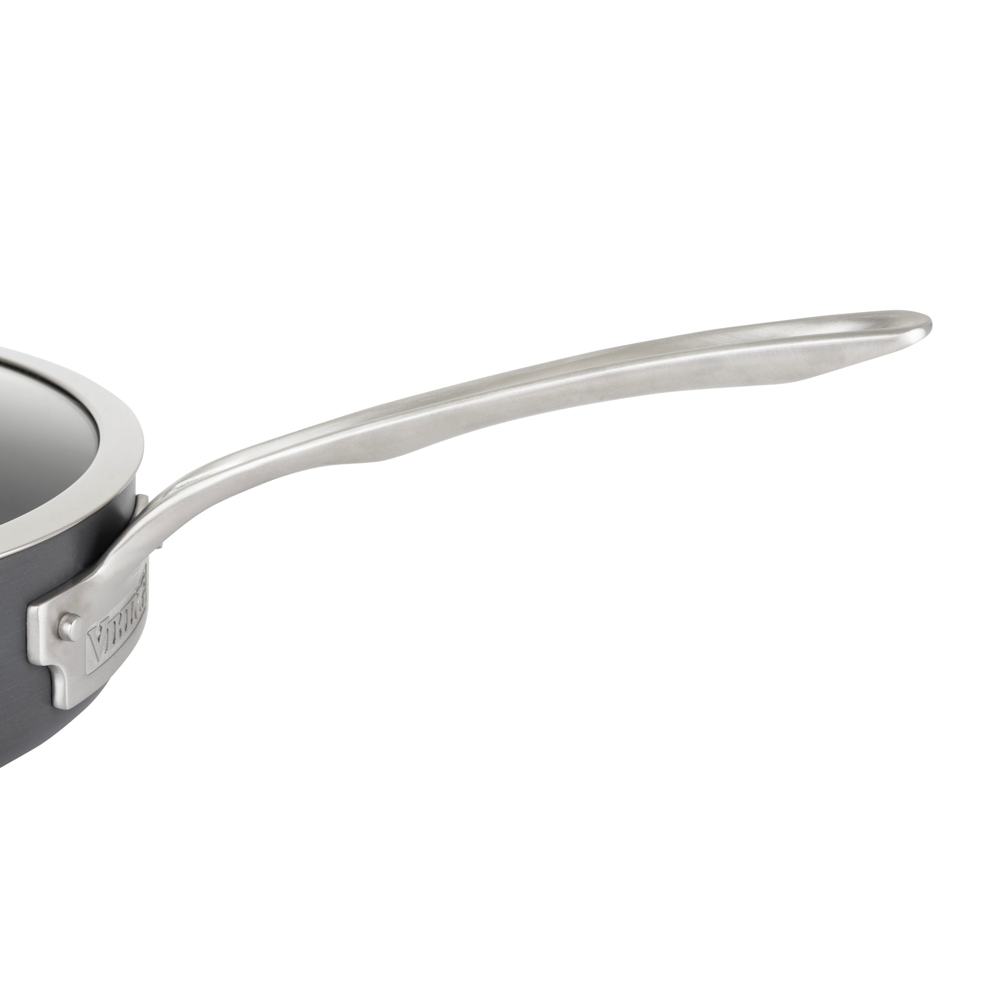 Close-up of a stainless steel handle attached to a dark-colored cooking pot or saucepan, with the pots rim and a portion of the lid visible on the left side.