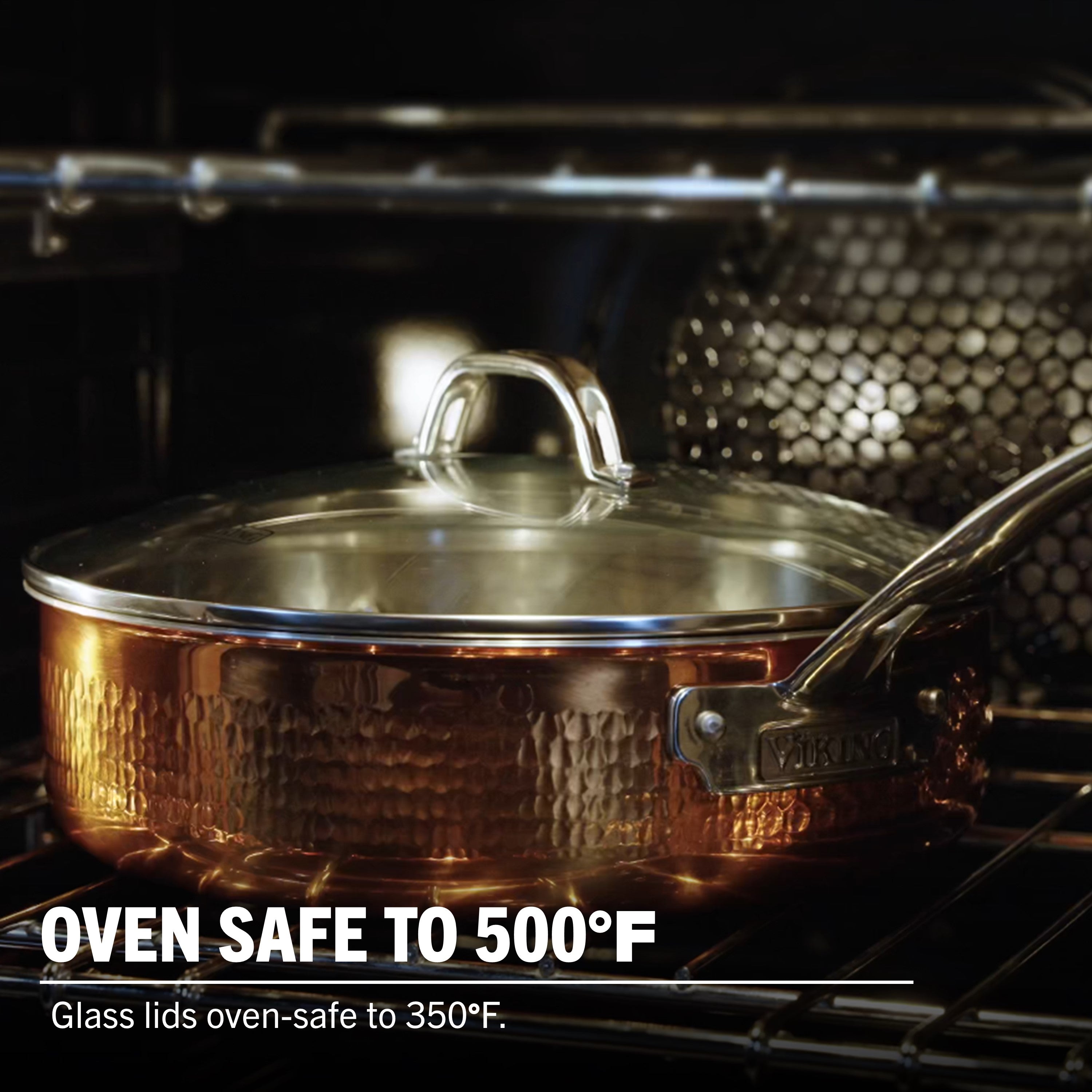 A Viking Culinary Products 3-Ply Hammered Copper Clad pan with stainless steel interior and tempered glass lid sits on an oven rack. Oven safe to 500°F; glass lids oven-safe to 350°F.