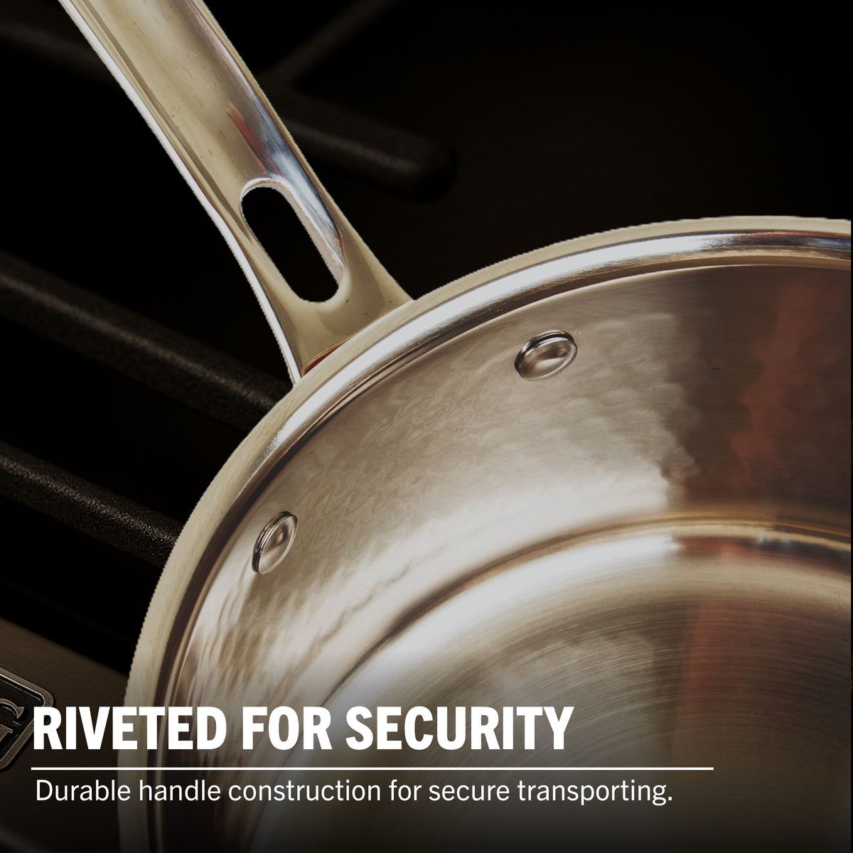 Close-up of Viking Culinary Products’ 3-Ply Hammered Copper Clad Cookware on a stovetop. Featuring riveted handles for secure transport and a premium stainless steel interior, this 10-piece set includes glass lids.