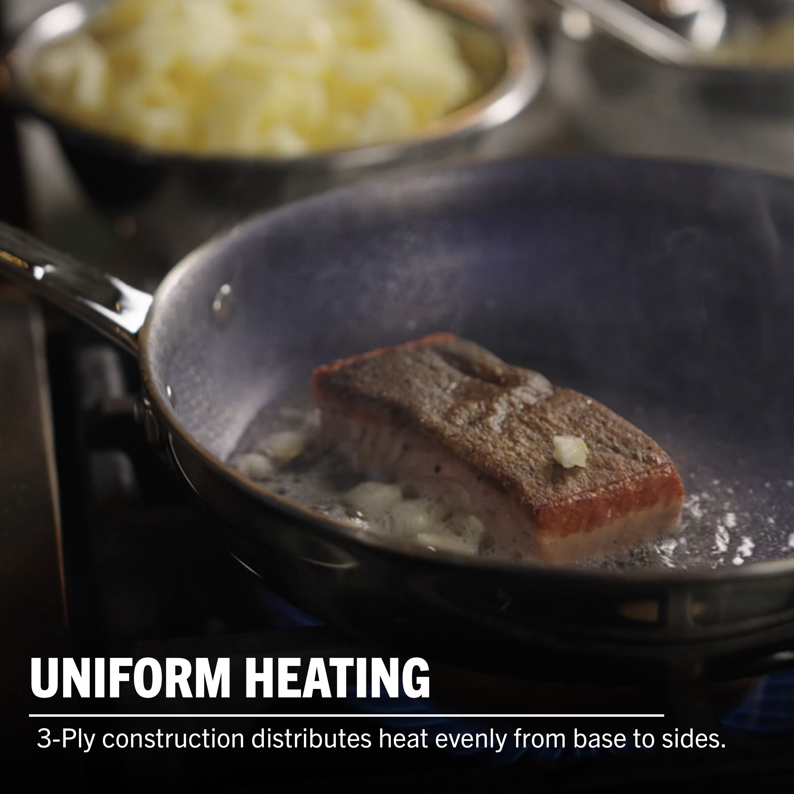 A piece of salmon cooks in the Viking 3-Ply Hybrid Plus Ceramic 8-inch Nonstick Fry Pan by Viking Culinary Products, with steam rising and diced onions nearby. Text: UNIFORM HEATING. 3-ply design ensures even heat distribution and works on induction cooktops.