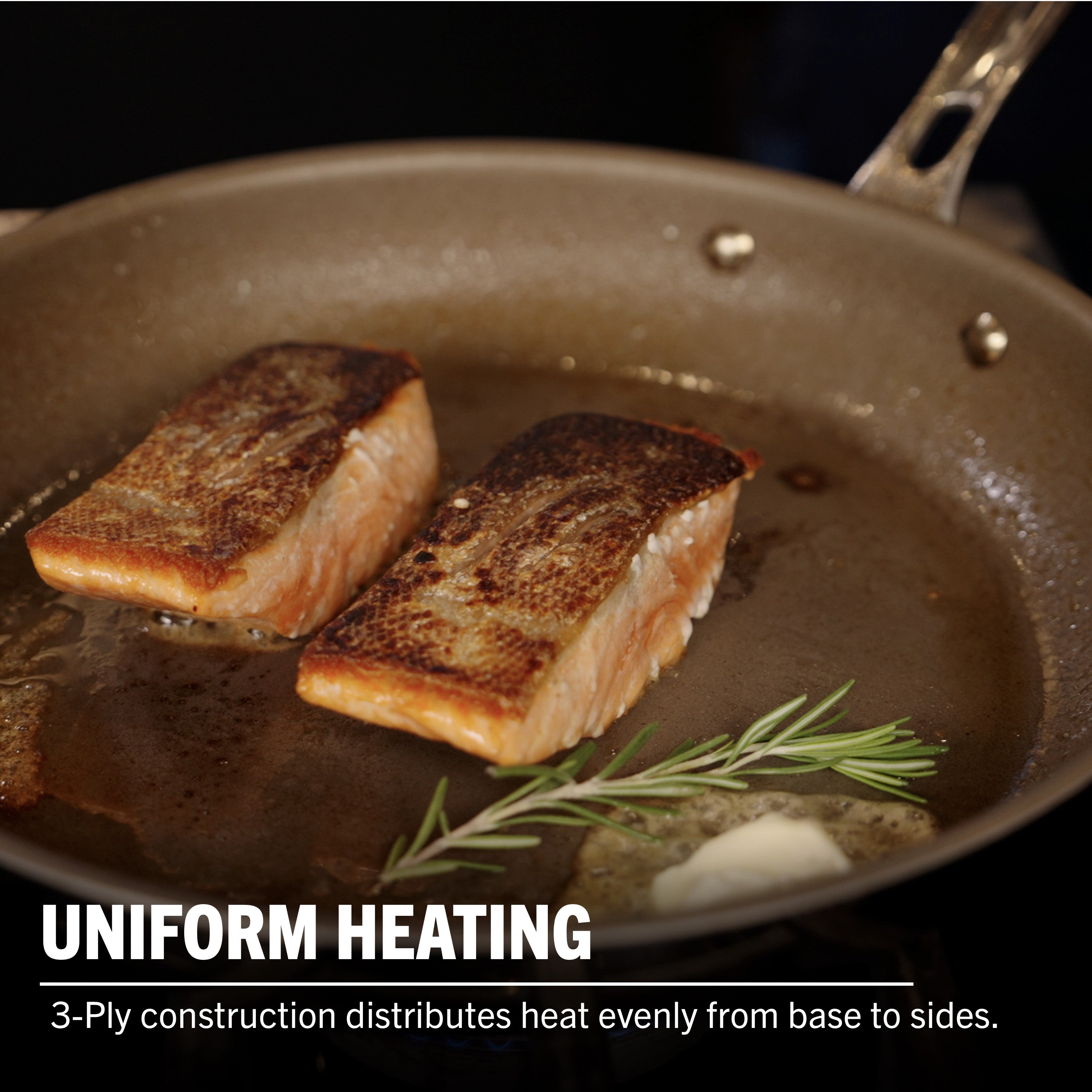 Two salmon fillets with crispy skin cook in a Viking PureGlide Pro 3-Ply Fry Pan. Caption: UNIFORM HEATING—Viking Culinary’s 3-ply design ensures even heat from base to sides for healthier cooking. Set includes 9.5" and 11" pans.
