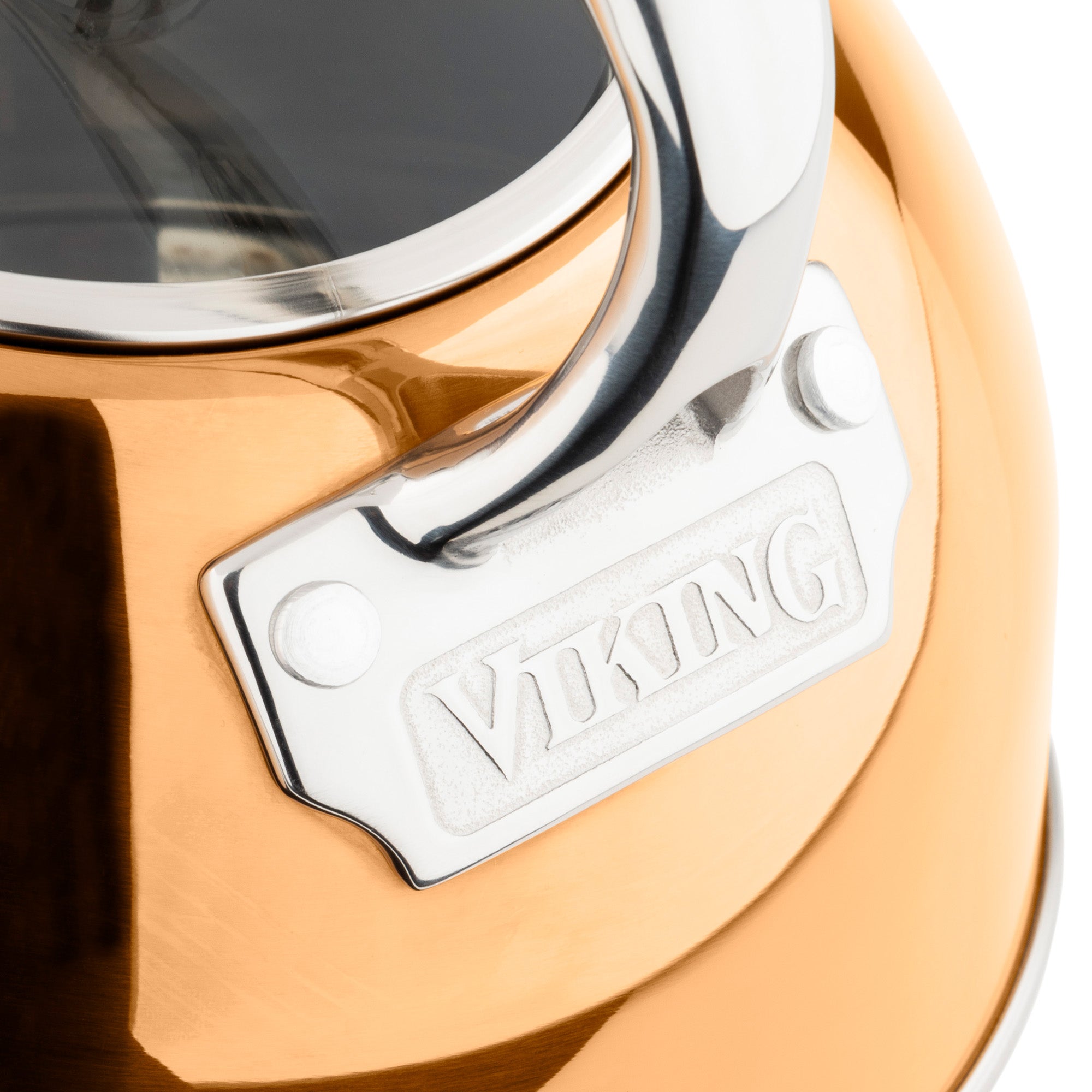 Close-up of the Viking 2.6-Quart Rose Gold Stainless Steel Whistling Kettle by Viking Culinary Products, featuring a silver handle attachment and engraved branding. Ideal for induction stovetops in any kitchen.