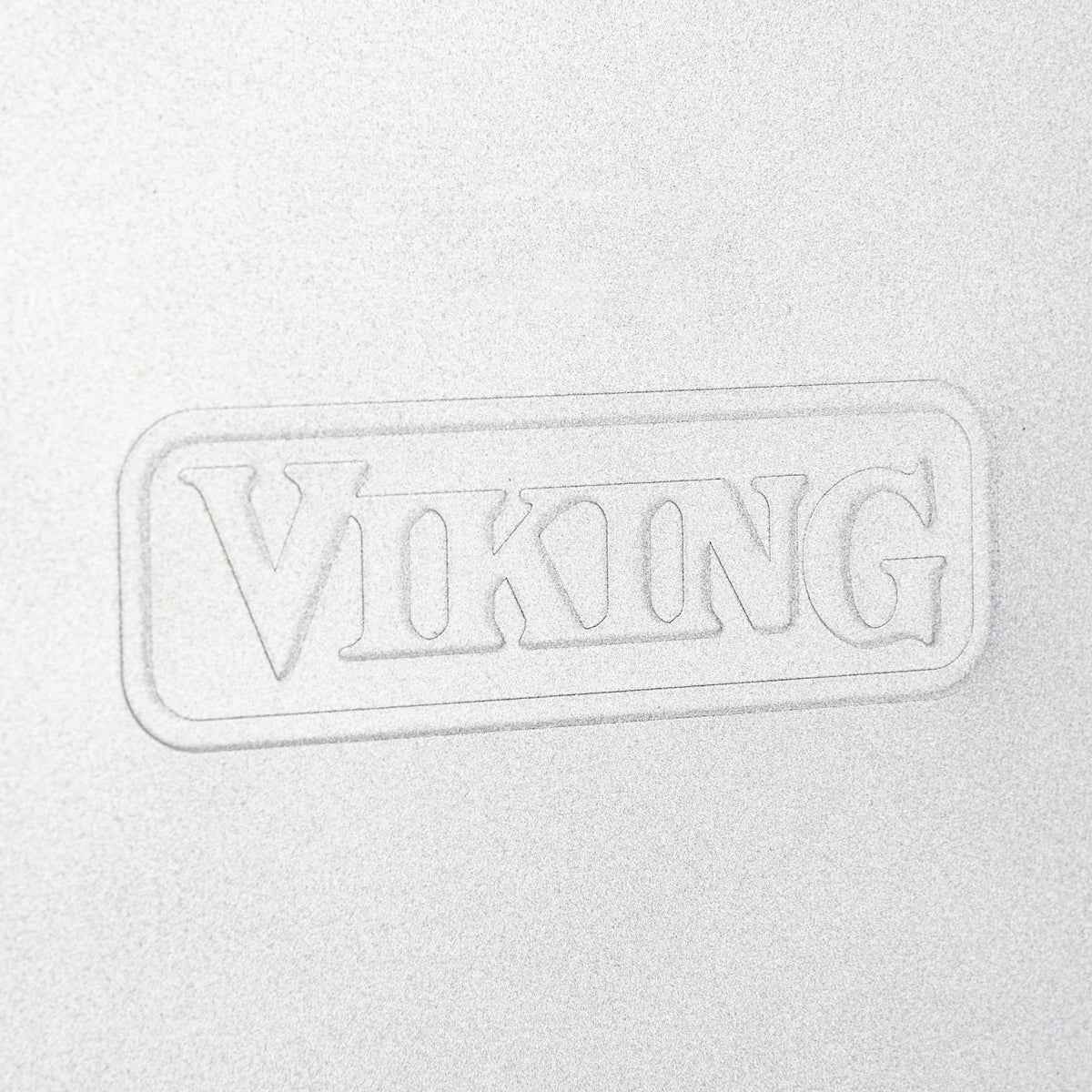 Close-up of the embossed word VIKING on a silver surface from the Viking 3-Piece Nonstick Aluminized Steel Baking Sheet Set by Viking Culinary Products, framed in a rectangular border.