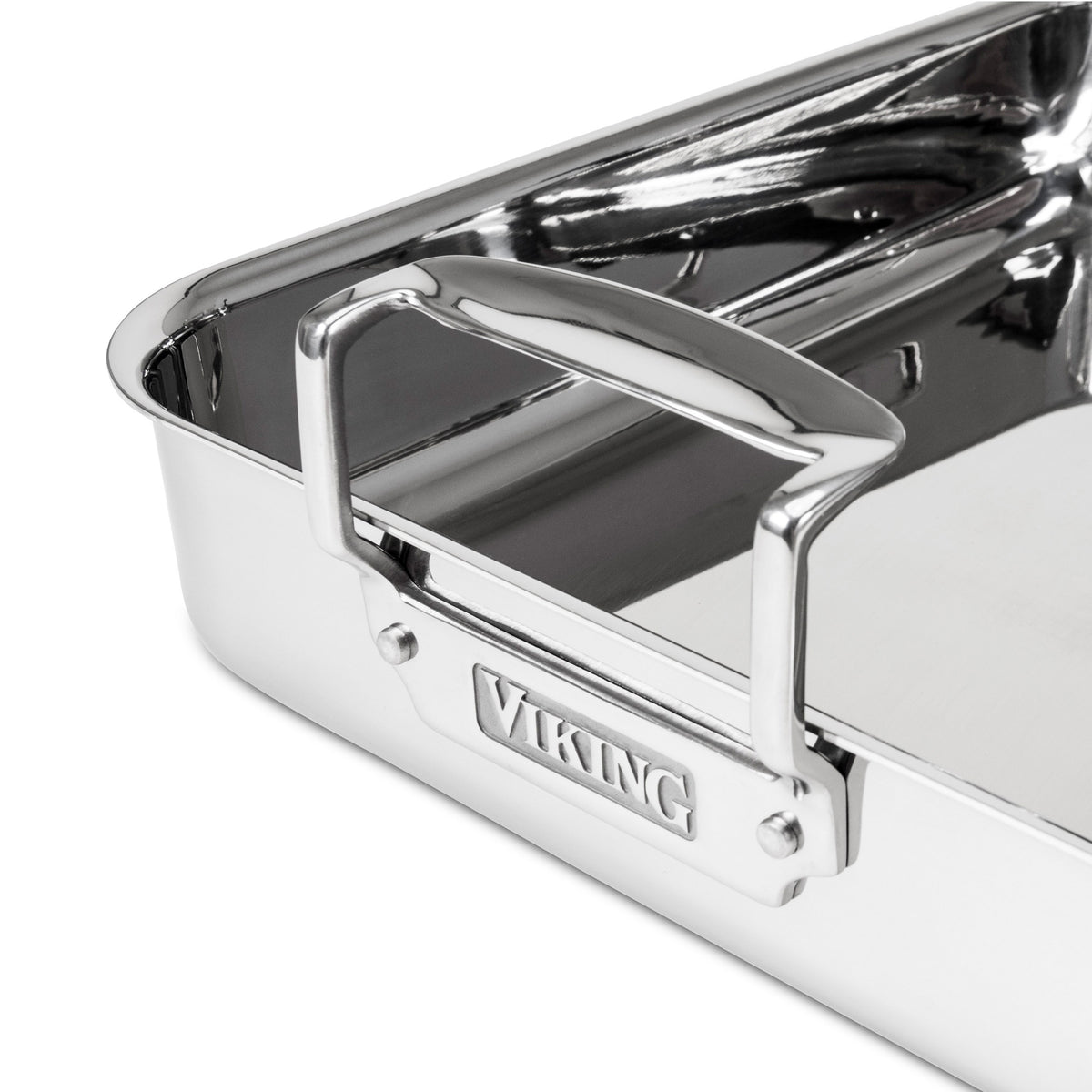 A close-up of the Viking Culinary Products 3-Ply Stainless Steel Roaster with sturdy handles, a nonstick rack, and “Viking” embossed on the side.