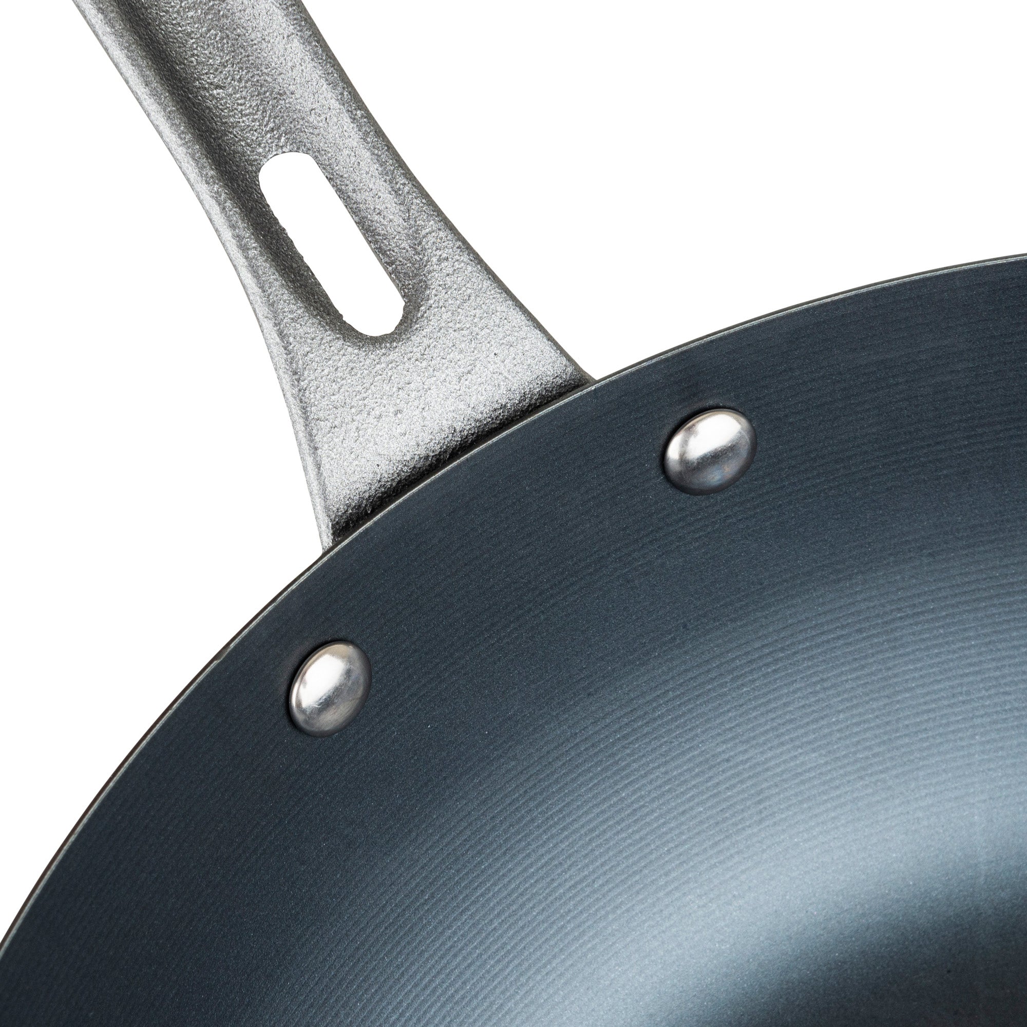 Close-up view of the Viking Culinary Products Viking Blue Carbon Steel 12-Inch Wok, showing part of the handle, two rivets, and the smooth, slightly textured interior surface.