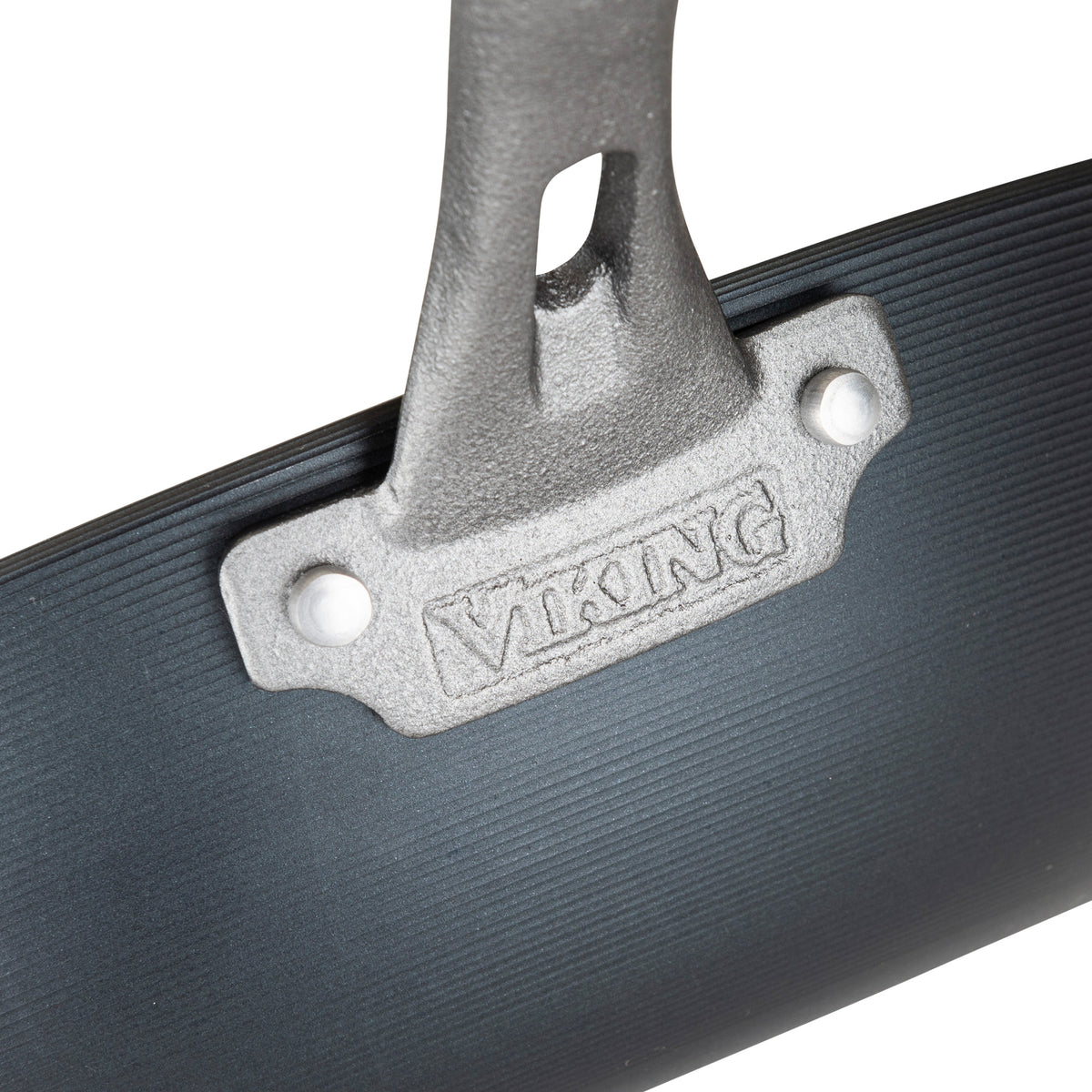 Close-up of a metal handle on a dark, ribbed surface with Viking Culinary Products embossed on a silver plate, showcasing the durable quality of the Viking Blue Carbon Steel 12-Inch Wok.