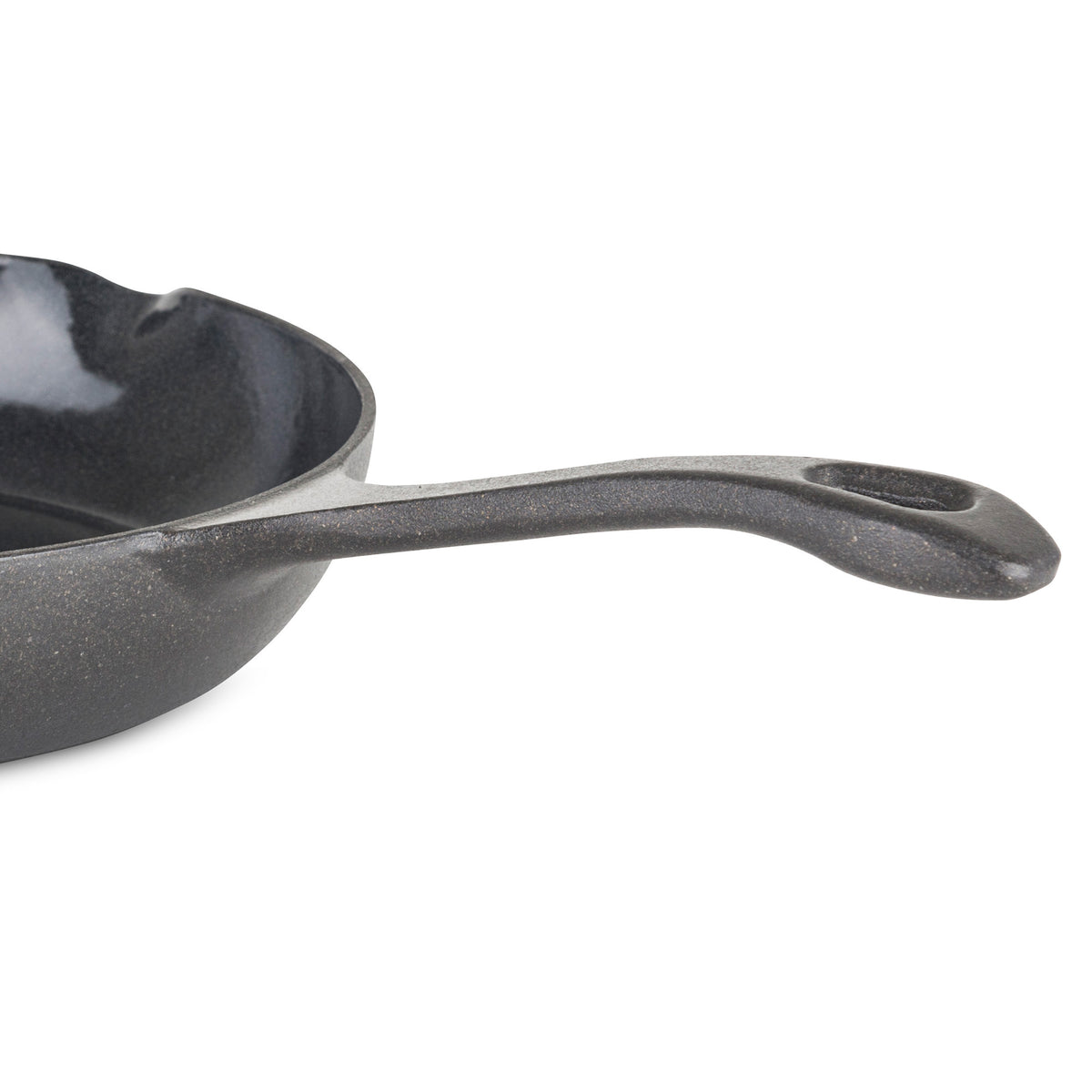 A close-up of the Viking Enameled Cast Iron 10.5-Inch Chefs Pan by Viking Culinary Products, highlighting part of the black skillet and its long handle with a hole at the end, set against a plain white background.