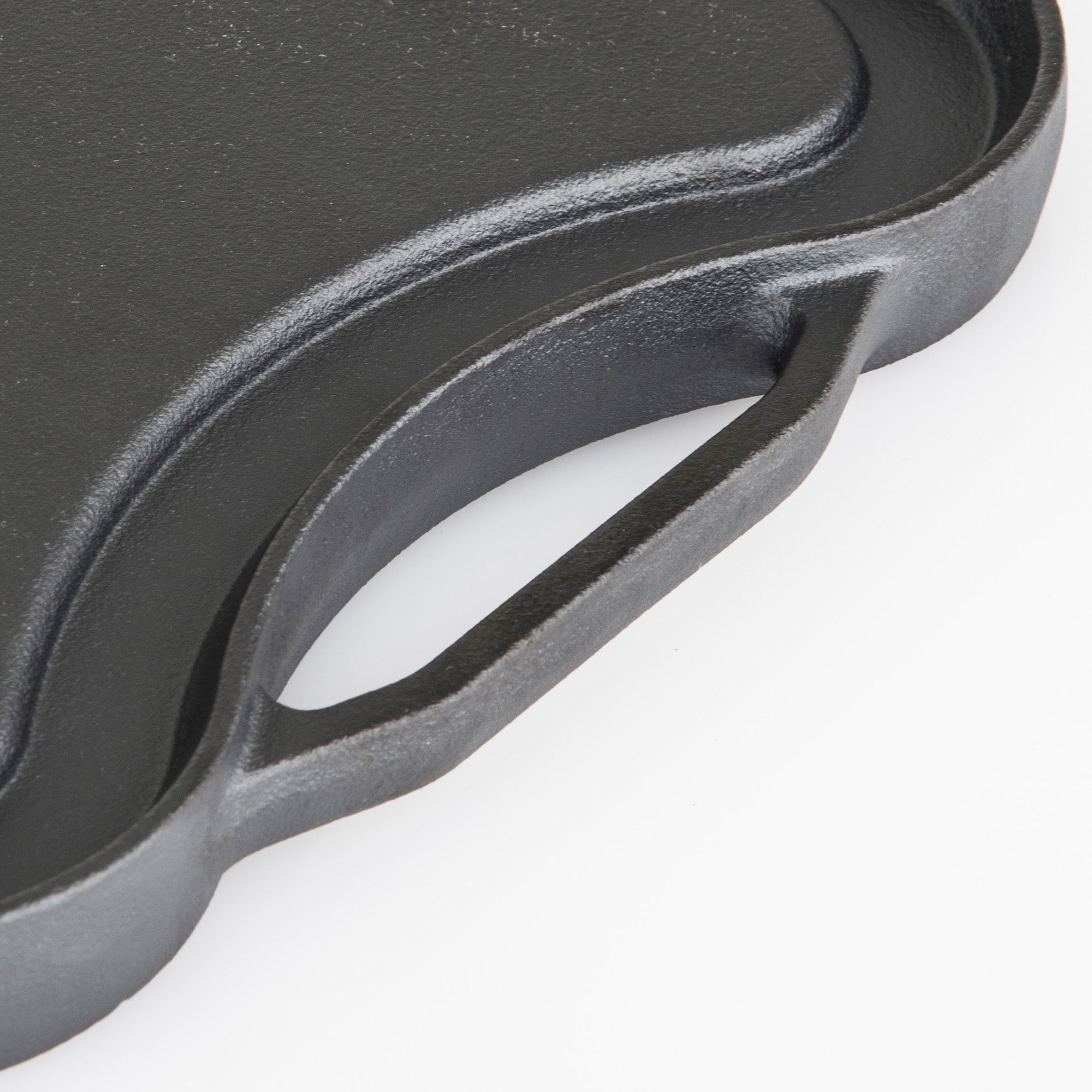 Close-up of the Viking Cast Iron 20-Inch Reversible Grill/Griddle Pan by Viking Culinary Products, featuring a textured surface, curved edge, and built-in handle, displayed against a white background.