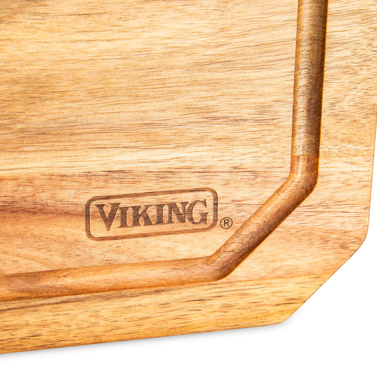 A close-up of the Viking Acacia Carving Board with Juice Groove by Viking Culinary Products, featuring the brand name engraved in bold letters within a rectangular border.