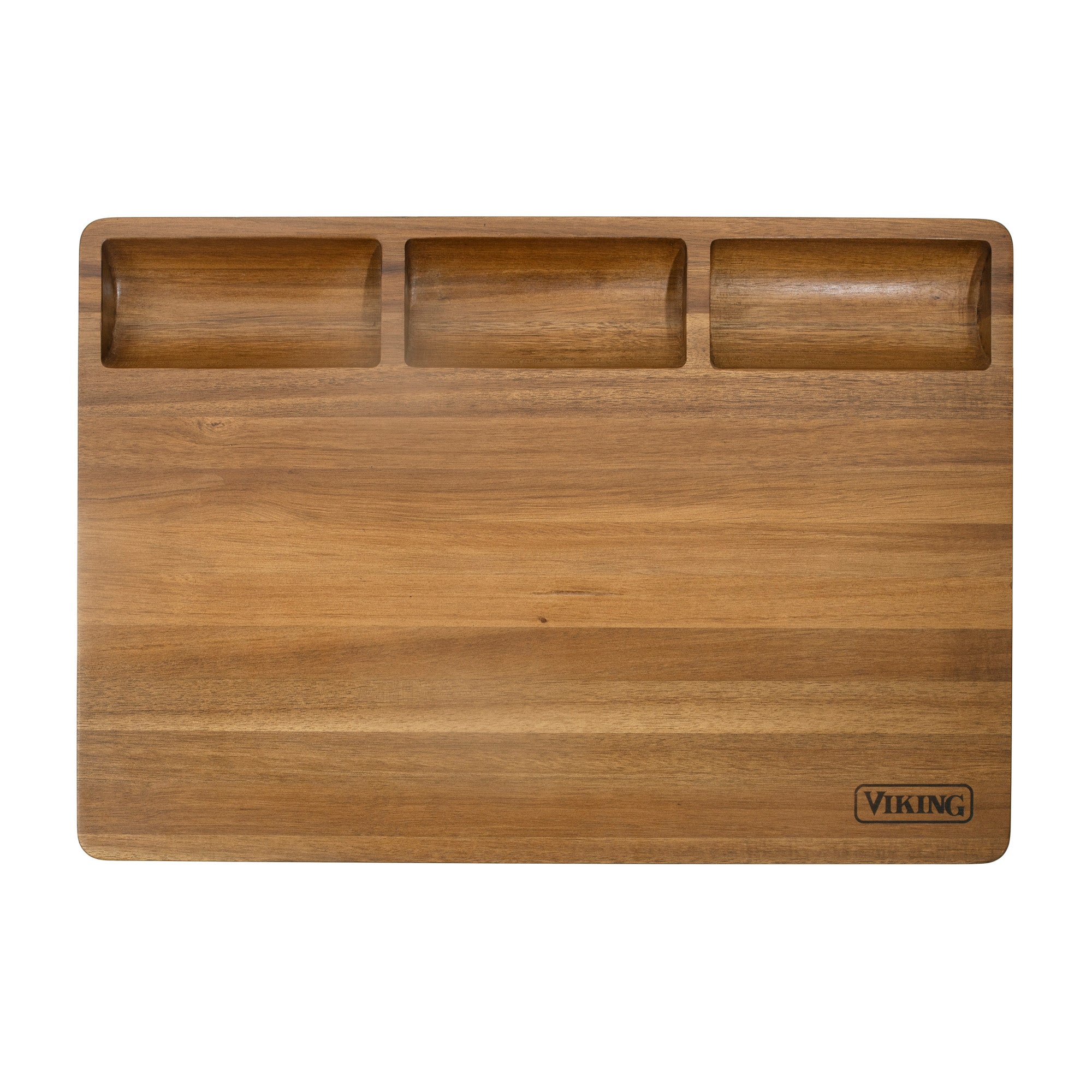 The Viking Acacia 20-Inch Reversible Butcher Block Prep and Carving Board from Viking Culinary Products features three shallow top compartments, a juice groove, and VIKING engraved in the bottom right corner.
