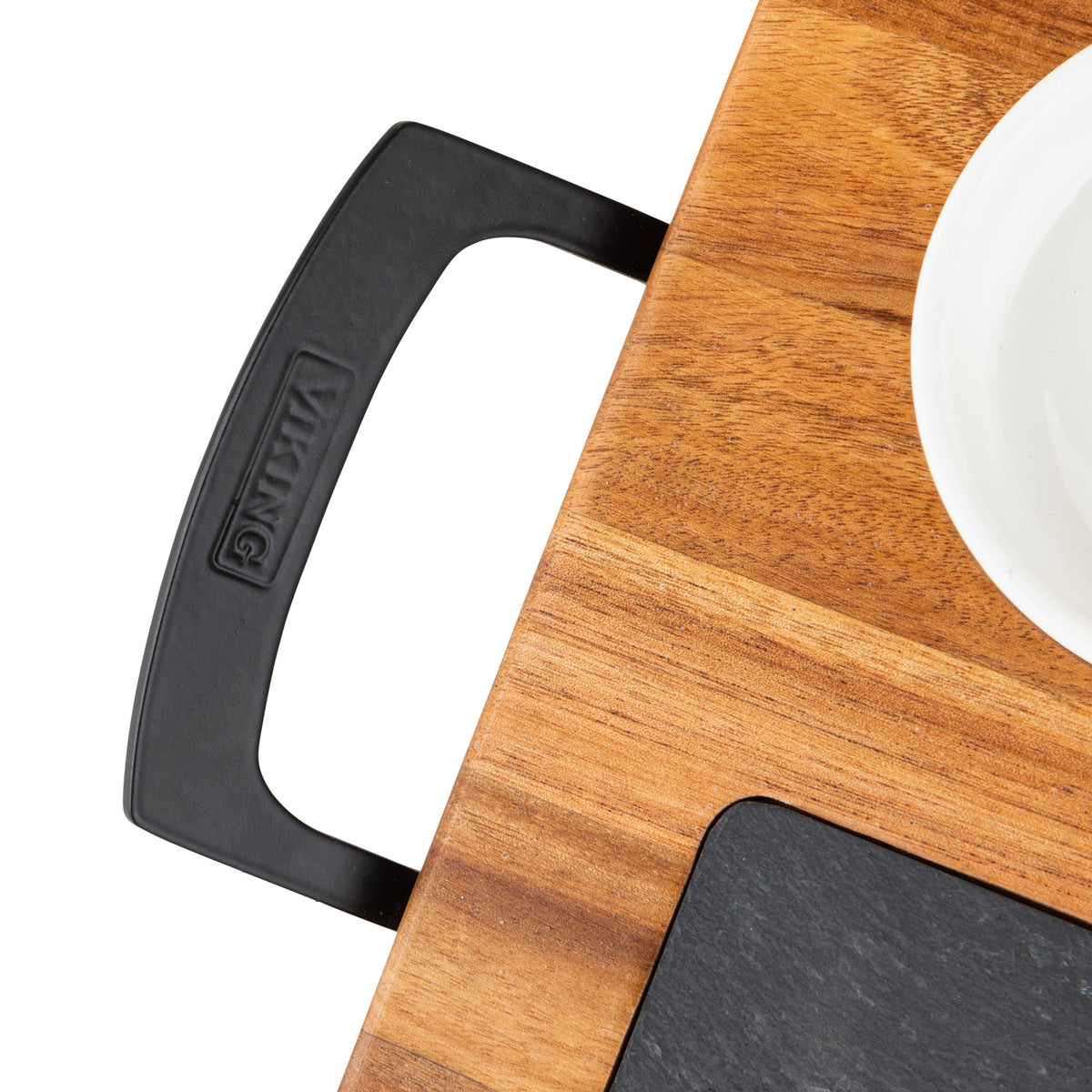 A close-up of the Viking Culinary Products 7-Piece Acacia Wood Slate Cheese Board Set shows its black metal handle labeled VIKING, with a white bowl and black slate section visible on the board.