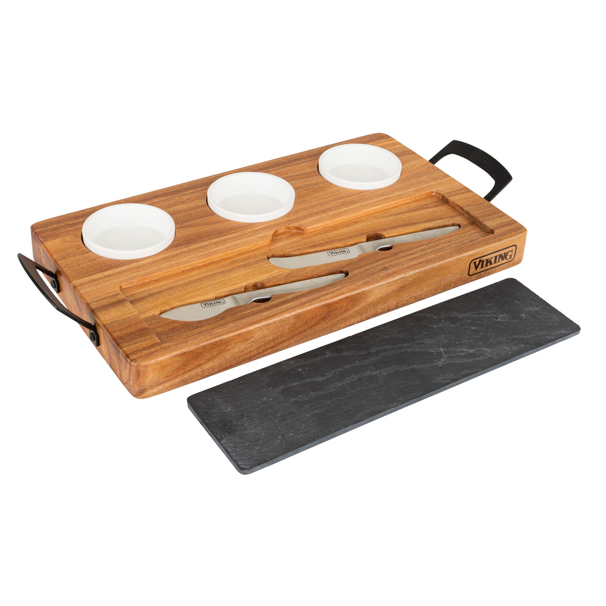 The Viking 7-Piece Acacia Wood Slate Cheese Board Set by Viking Culinary Products features three white ceramic bowls, cheese knives in grooves, black metal handles, and a separate rectangular slate serving board.