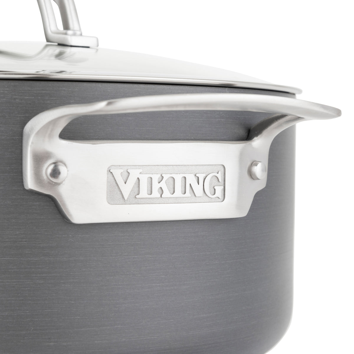 Close-up of a Viking Culinary Products Hard Anodized Nonstick 6-Quart Dutch Oven with Glass Lid, featuring a shiny handle engraved with VIKING and the lids handle visible in the top left corner.