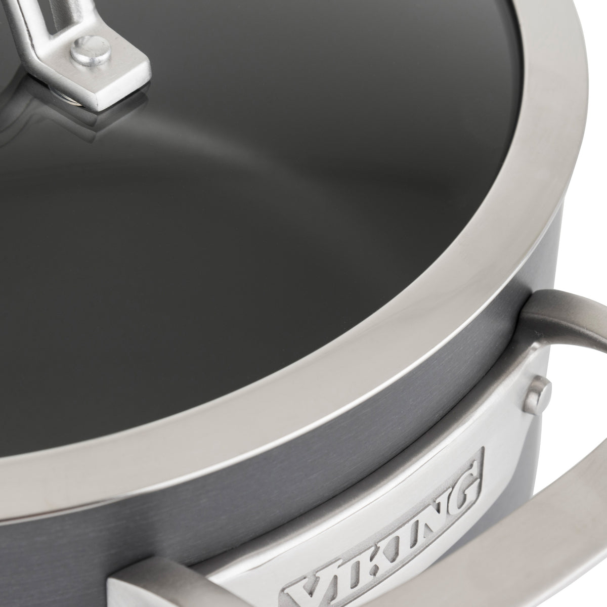 Close-up of a Viking Culinary Products Hard Anodized Nonstick 6-Quart Dutch Oven with glass lid, highlighting the handle, rim, and part of the brand name plate on the side.