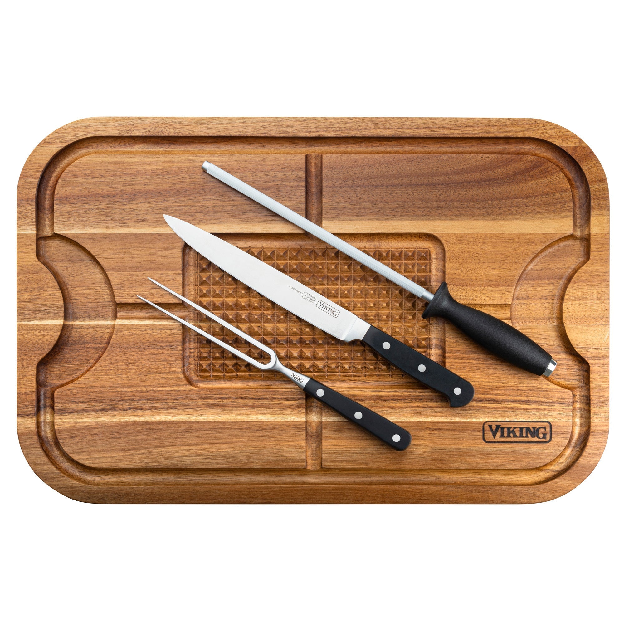 The Viking Acacia Wood Cutting Board with 3-Piece Stainless Steel Carving Set from Viking Culinary Products includes a juice-groove cutting board, carving fork, sharp carving knife, and sharpening steel—all with sleek black handles.